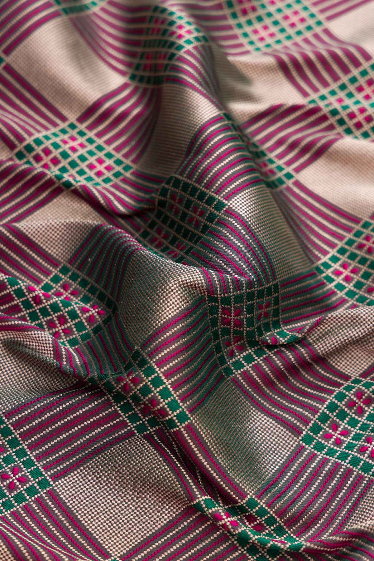 Close up of Dark Pink Dual Tone Banarasi Silk Saree with Zari Brocade on the body and Fancy Border displaying folds