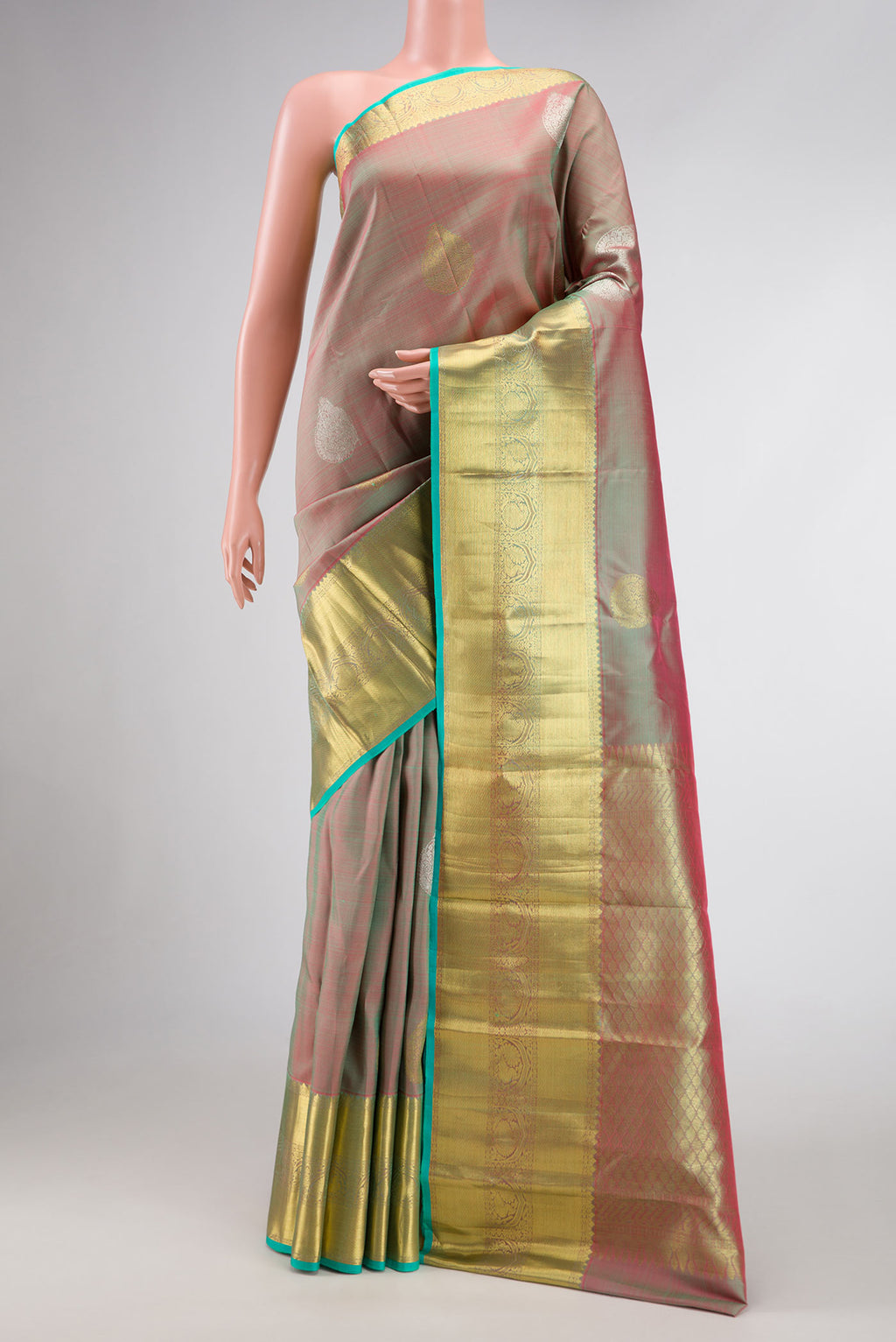 Green Dual Tone Kanjivaram Silk Saree with Zari Brocade on the body and Zari Border.  displayed on a mannequin