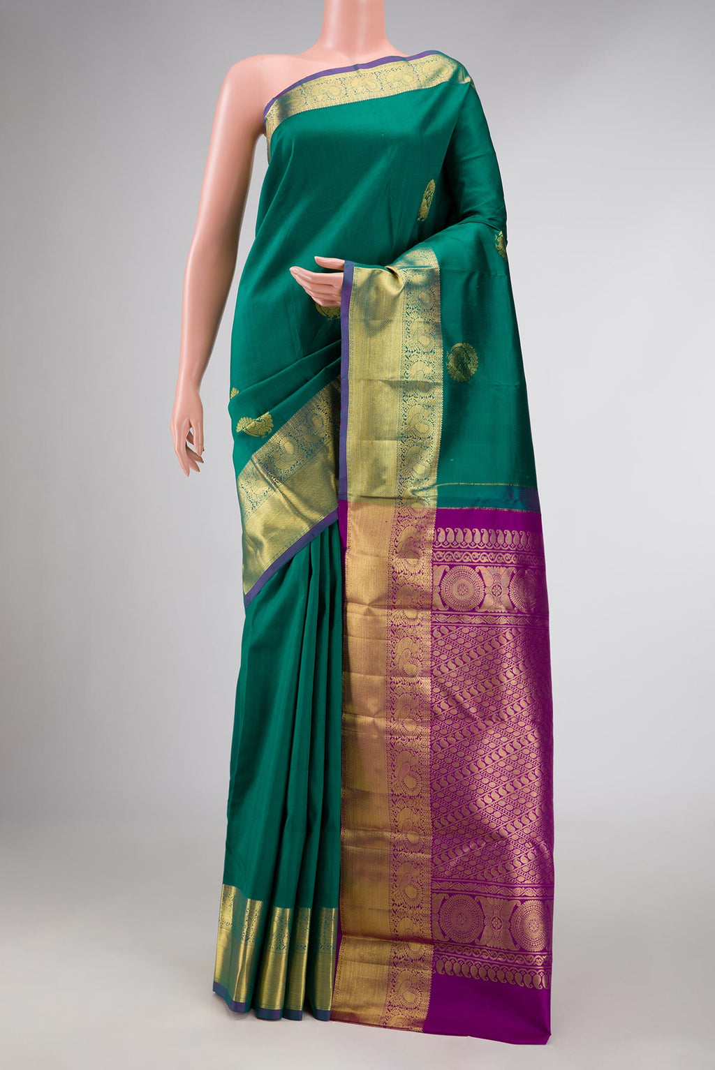 Green Dual Tone Kanchipuram Silk Saree with Zari Butta on the body and Zari Border displayed on a mannequin