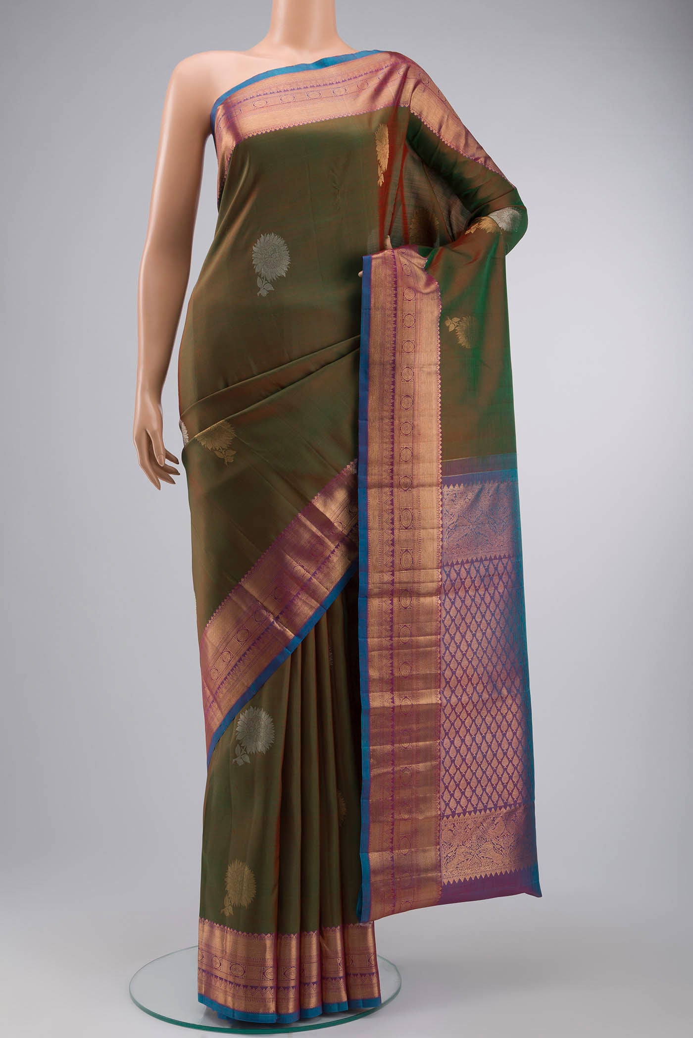 Green Kanchipuram Silk Saree with Zari Butta on the body and Zari Border displayed on a mannequin