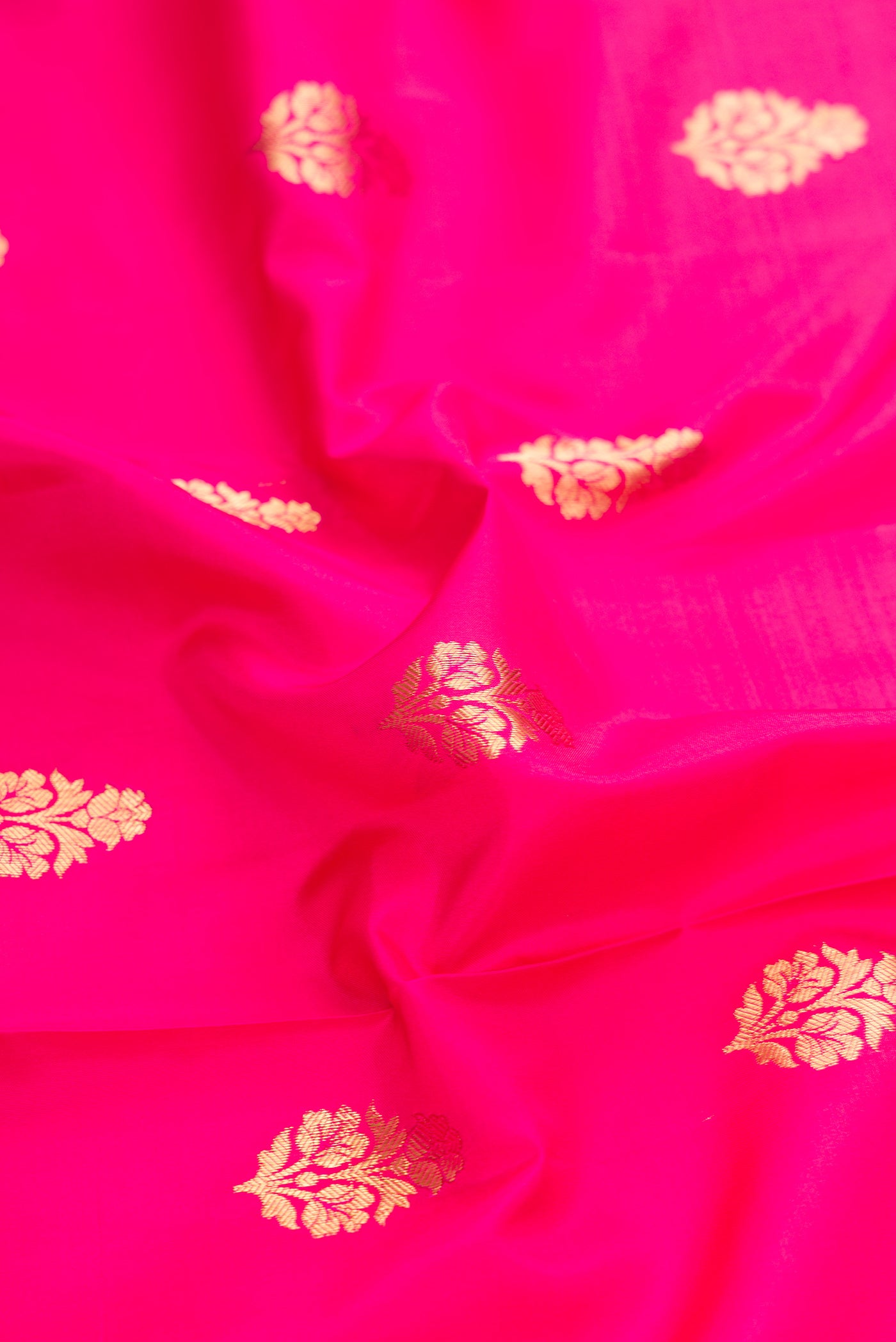 Close up of Pink Dual Tone Kanjivaram Silk Saree with Zari Butta on the body and Zari Border.  displaying folds