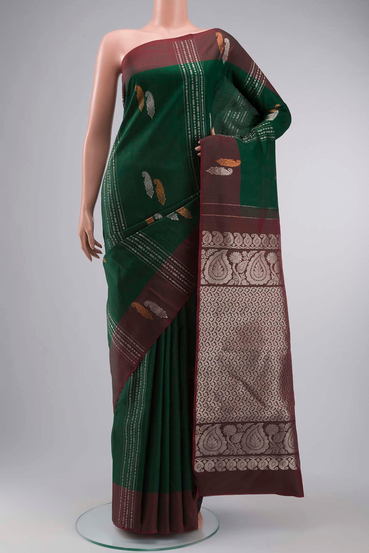 Green Kanchipuram Silk Saree with Zari Butta on the body and Zari Border displayed on a mannequin