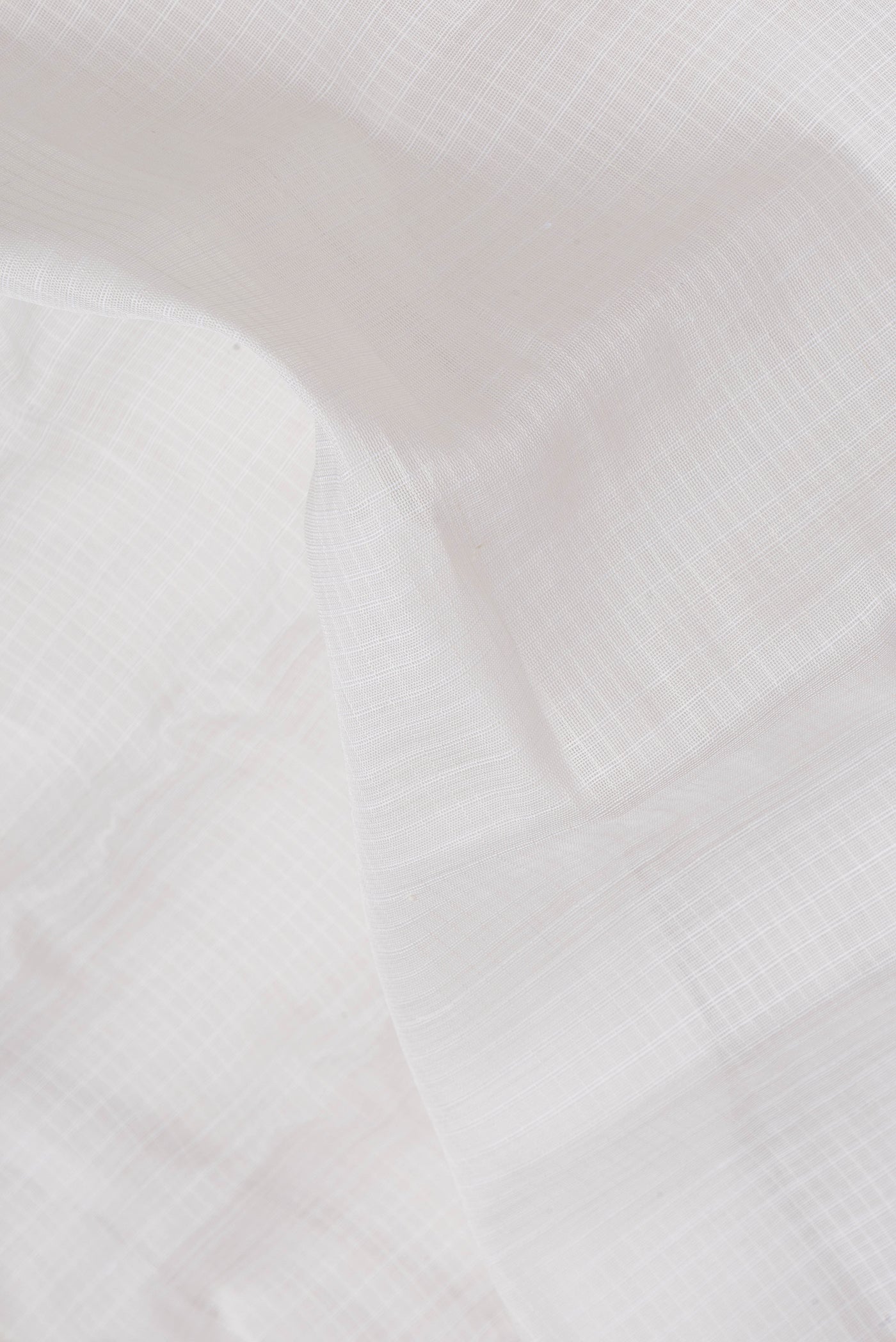 Close up of White Dual Tone Kanchipuram Silk Saree with Checked design on the body and Zari Border.  displaying folds