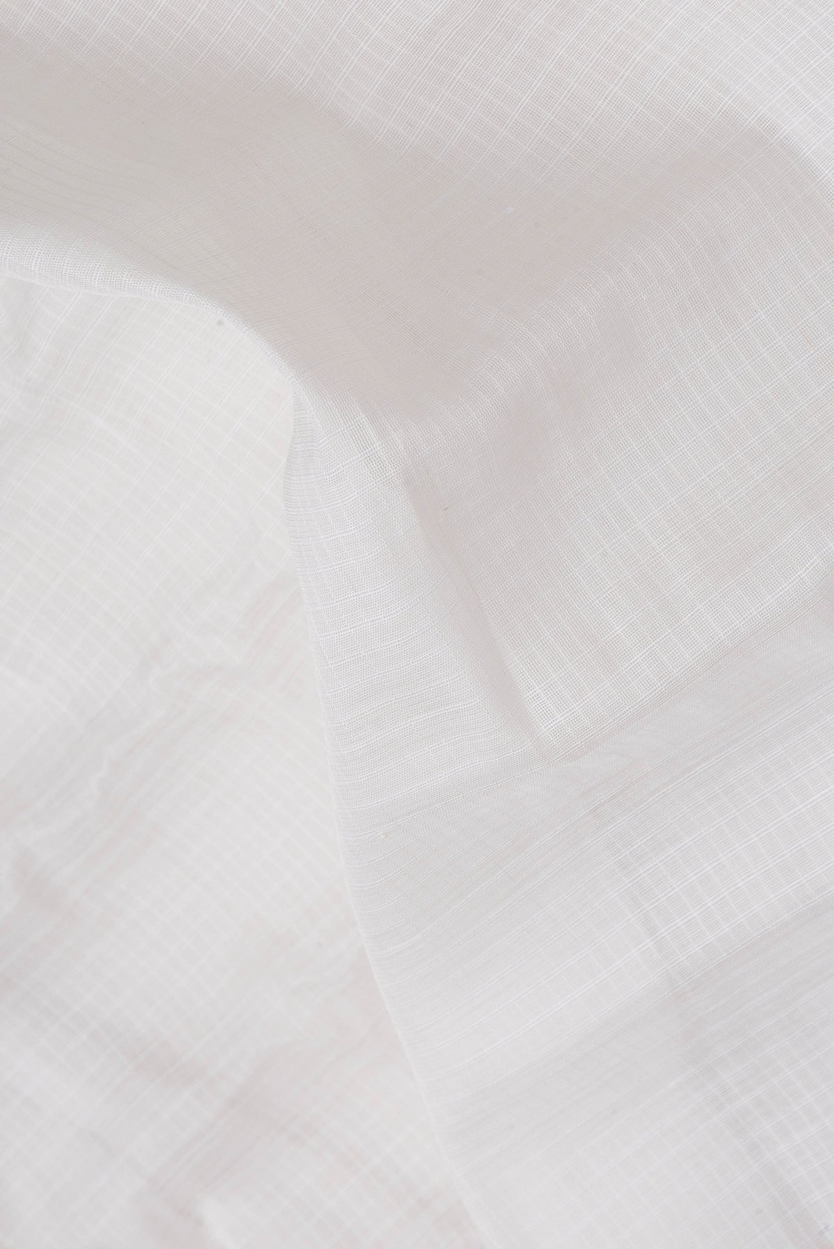 Close up of White Dual Tone Kanchipuram Silk Saree with Checked design on the body and Zari Border.  displaying folds