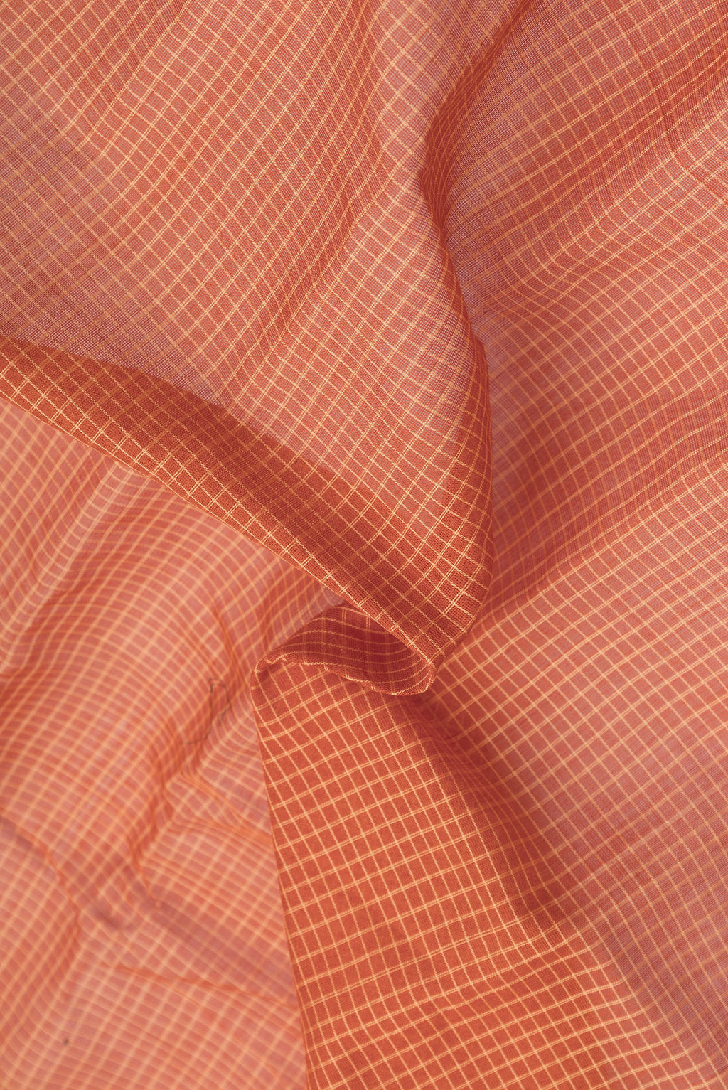 Close up of Orange Dual Tone Gadwal Silk Cotton Saree with Checked design on the body and Zari Border.  displaying folds