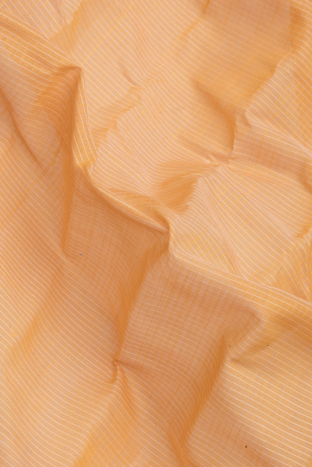 Close up of Orange Dual Tone Kanchipuram Silk Saree with Checked design on the body and Zari Border.  displaying folds