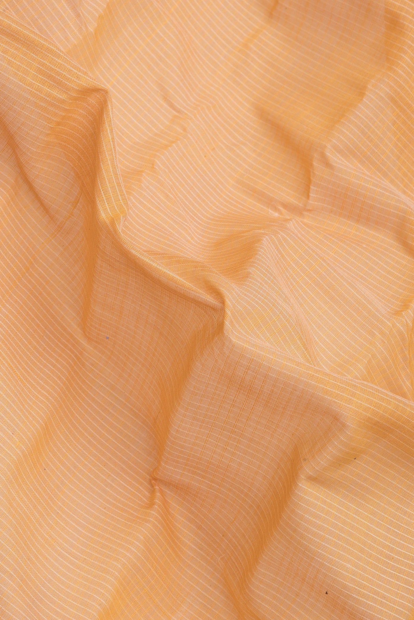 Close up of Orange Dual Tone Kanchipuram Silk Saree with Checked design on the body and Zari Border.  displaying folds