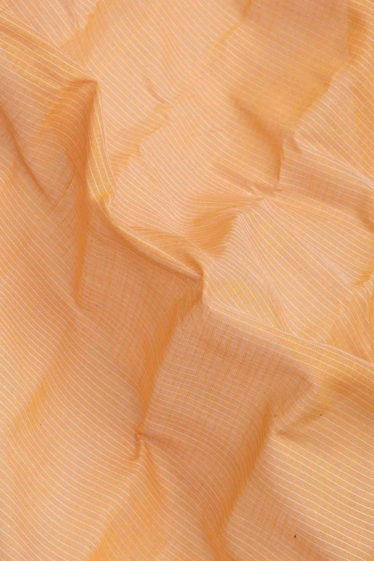 Close up of Orange Dual Tone Kanchipuram Silk Saree with Checked design on the body and Zari Border.  displaying folds