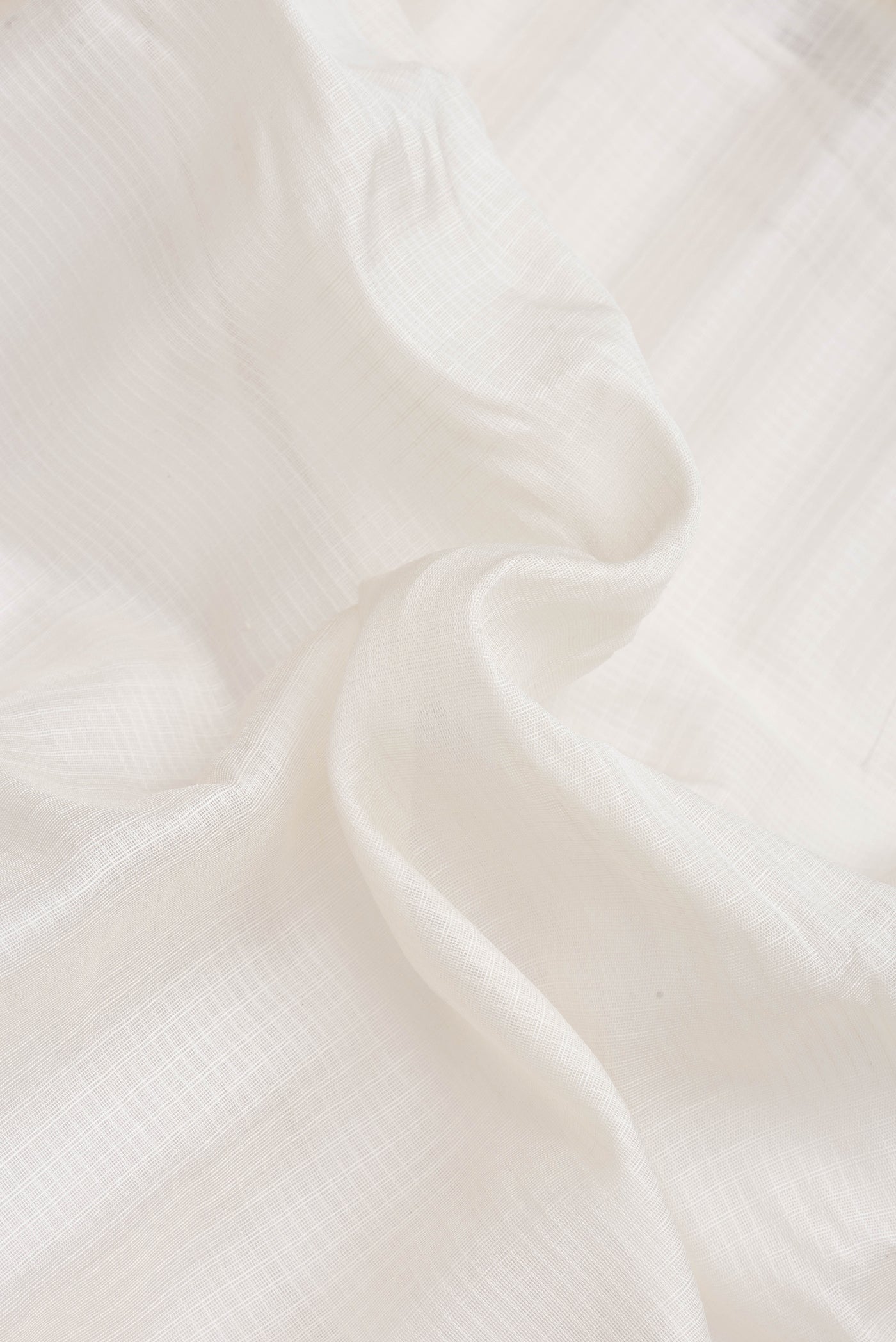 Close up of Off White Dual Tone Kanchipuram Silk Saree with Checked design on the body and Zari Border.  displaying folds