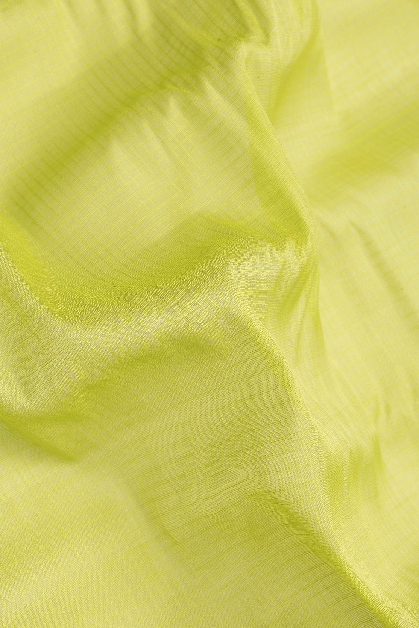 Close up of Parrot Green Dual Tone Gadwal Silk Saree with Checked design on the body and Zari Border.  displaying folds