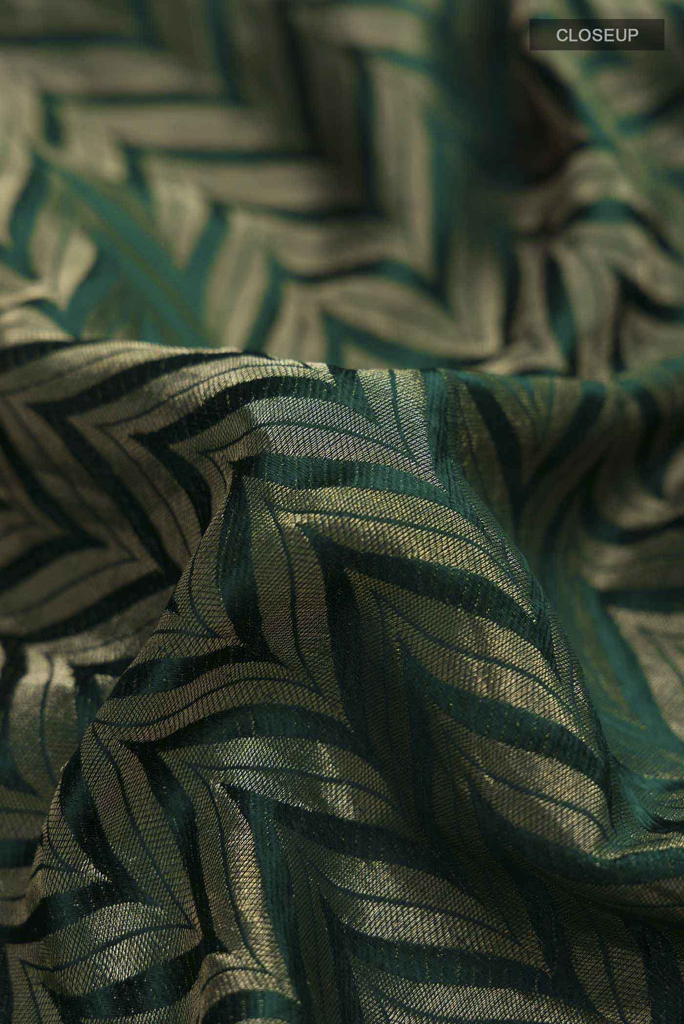 Close up of Green Mysore Crepe Saree with Zari Brocade on the body and Zari Border displaying folds