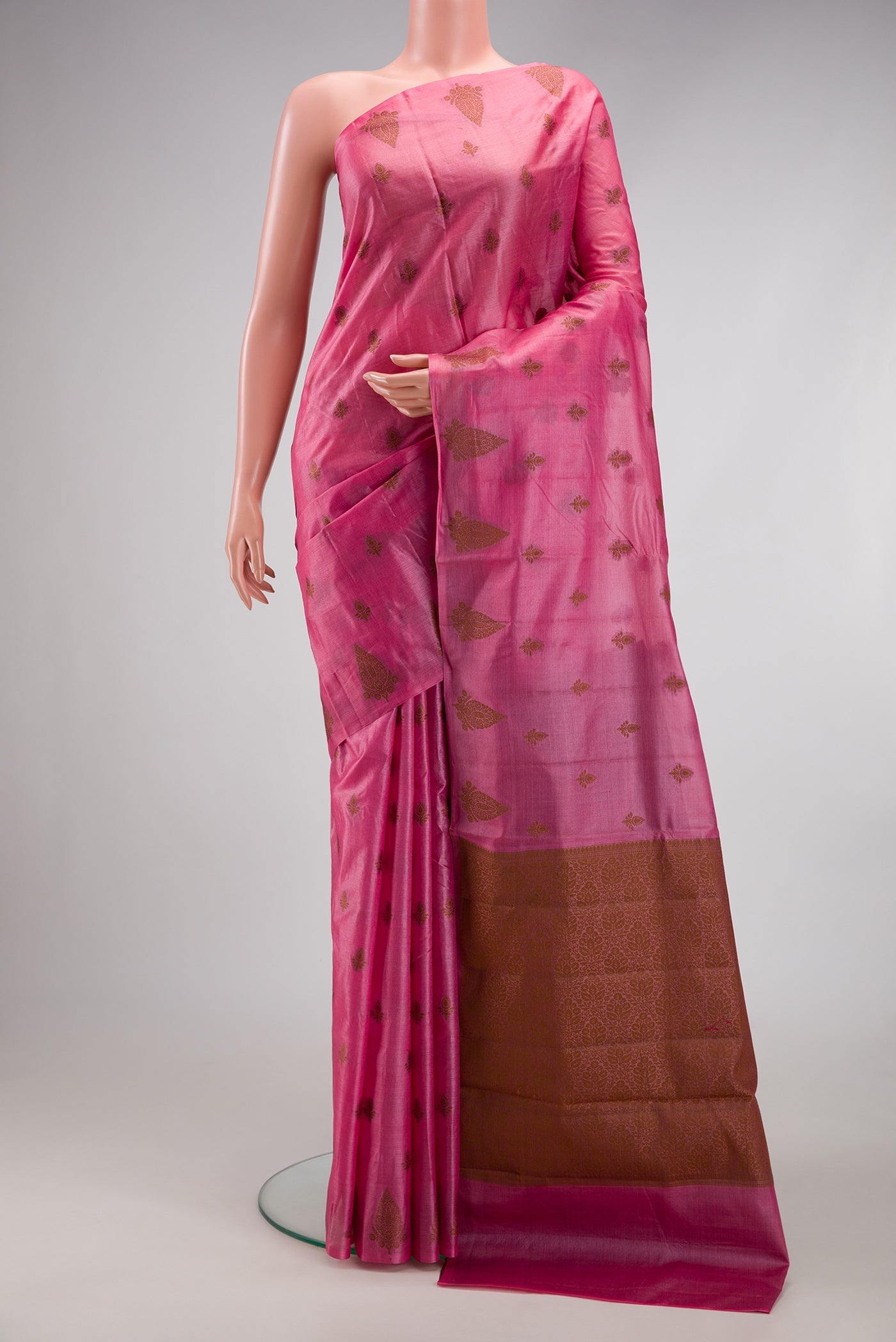 Pink Tussar Silk Saree with Thread Butta on the body and Fancy Border.  displayed on a mannequin