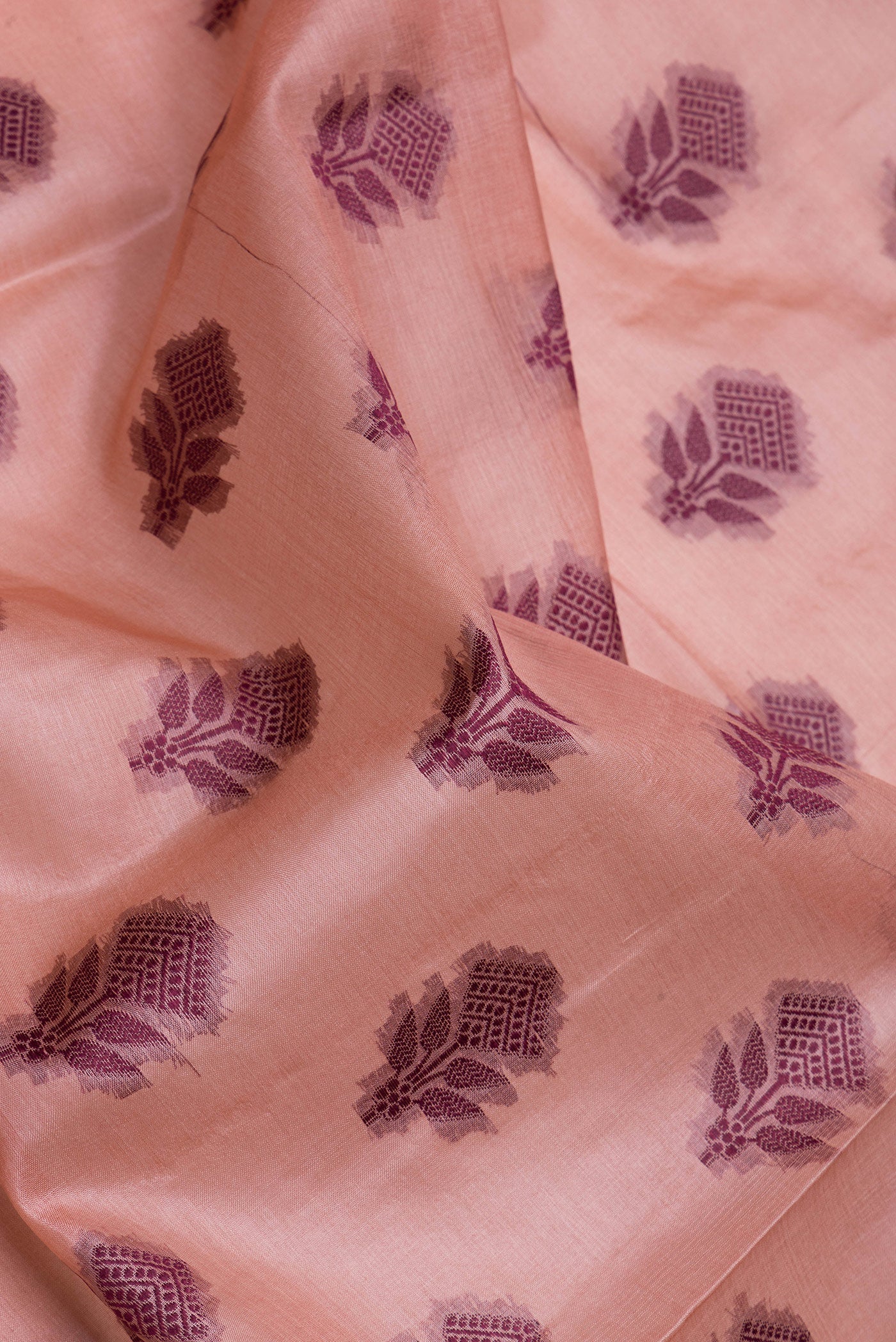 Close up of Peach Tussar Silk Saree with Thread Butta on the body and Thread Border.  displaying folds