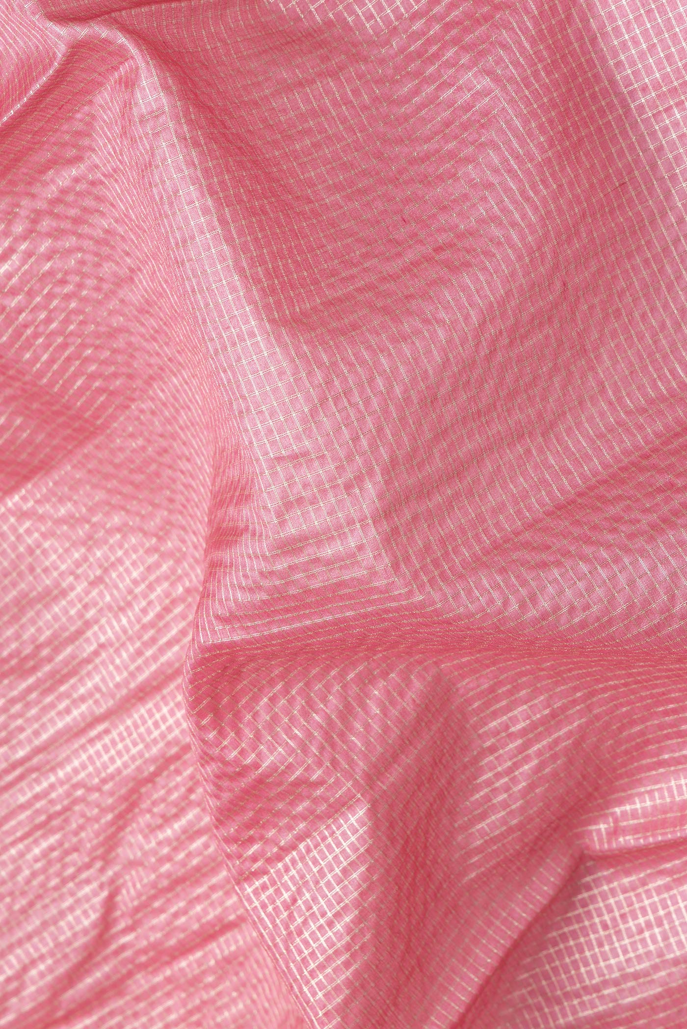 Close up of Pink Dual Tone Tussar Silk Saree with Checked design on the body and Zari Border.  displaying folds