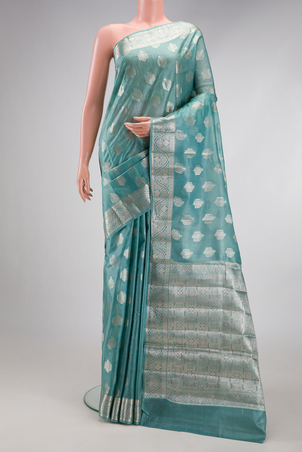 Sky Blue Tussar Silk Saree with Zari Butta on the body and Zari Border.  displayed on a mannequin