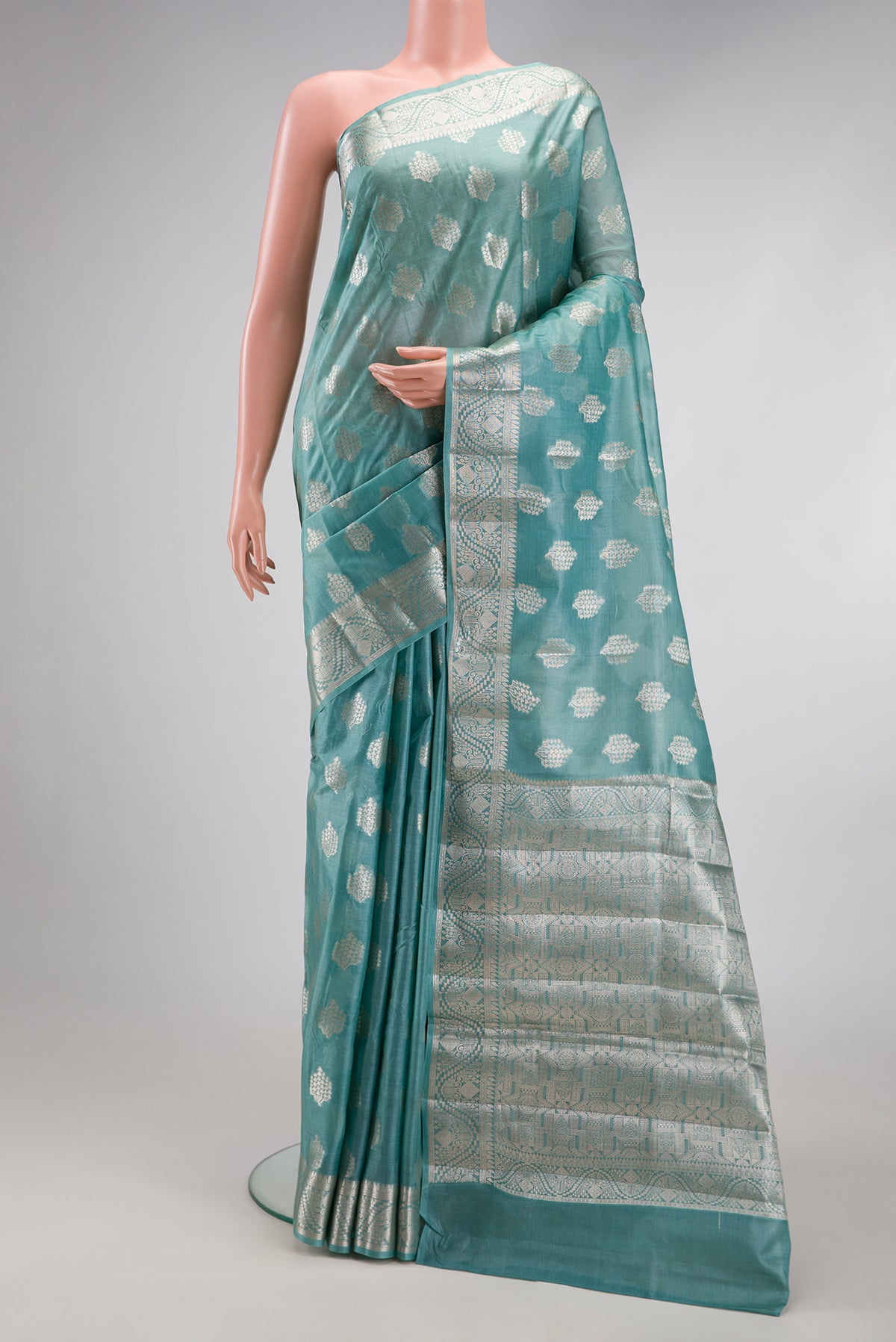 Sky Blue Tussar Silk Saree with Zari Butta on the body and Zari Border.  displayed on a mannequin