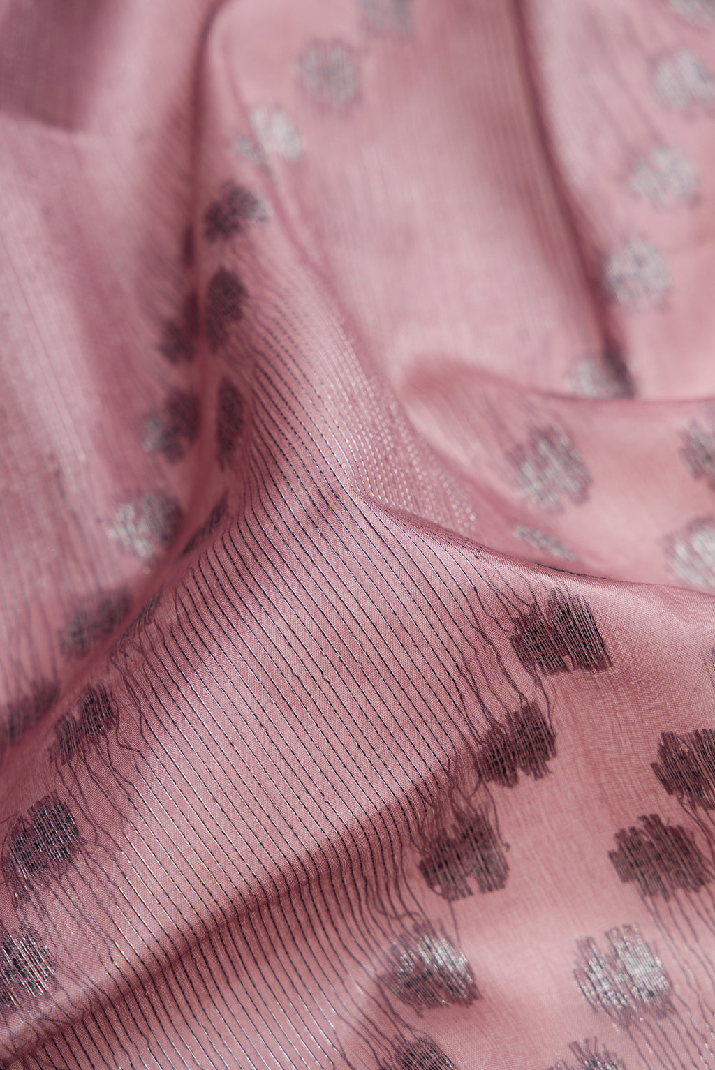 Close up of Mauve Banarasi Tussar Silk Saree with Zari Brocade on the body and Zari Border.  displaying folds