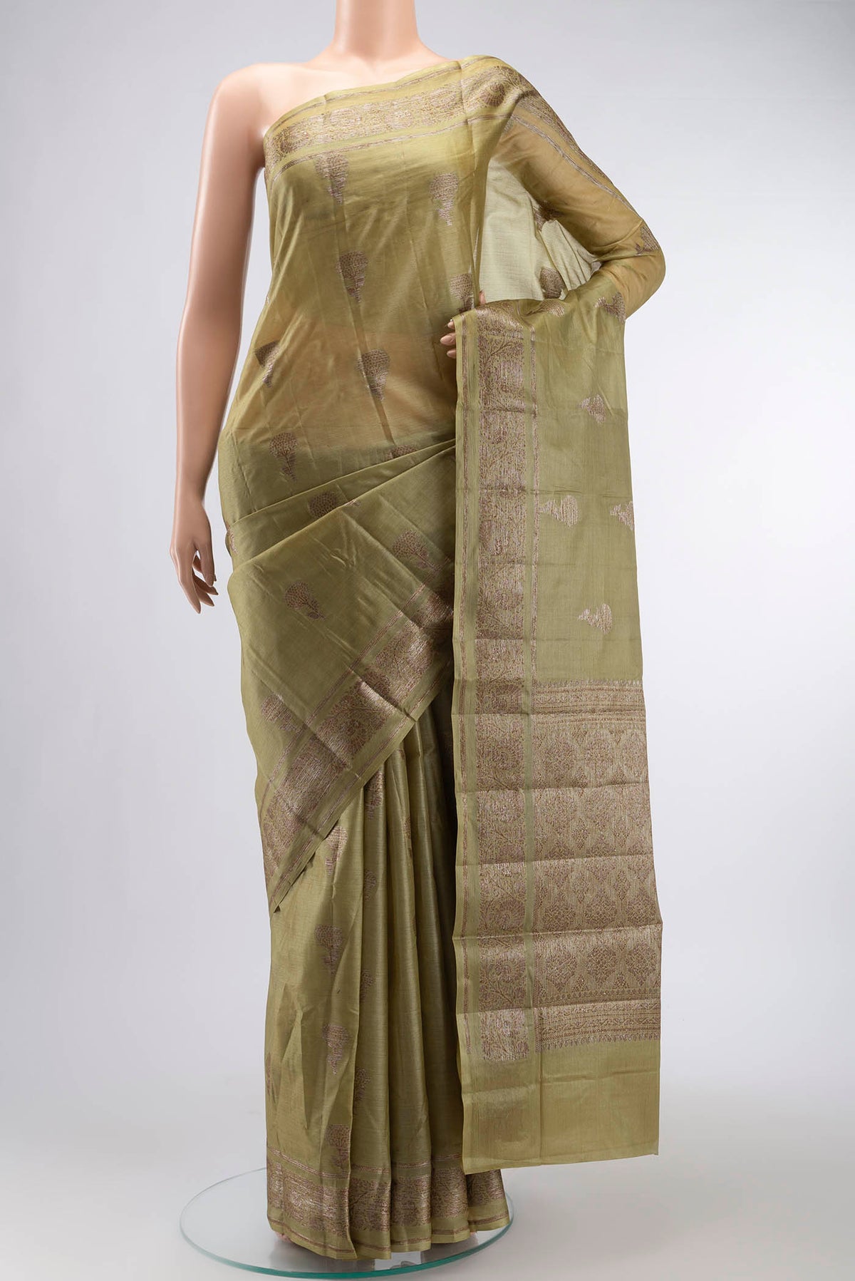 Green Tussar Silk Saree with Zari Butta on the body and Zari Border displayed on a mannequin
