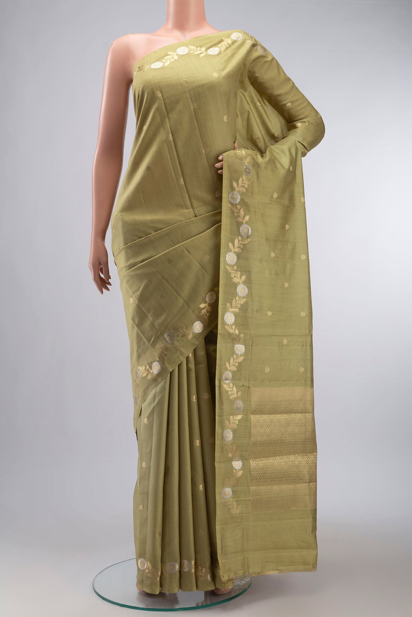 Green Banarasi Raw Silk Saree with Zari Butta on the body and Zari Border displayed on a mannequin