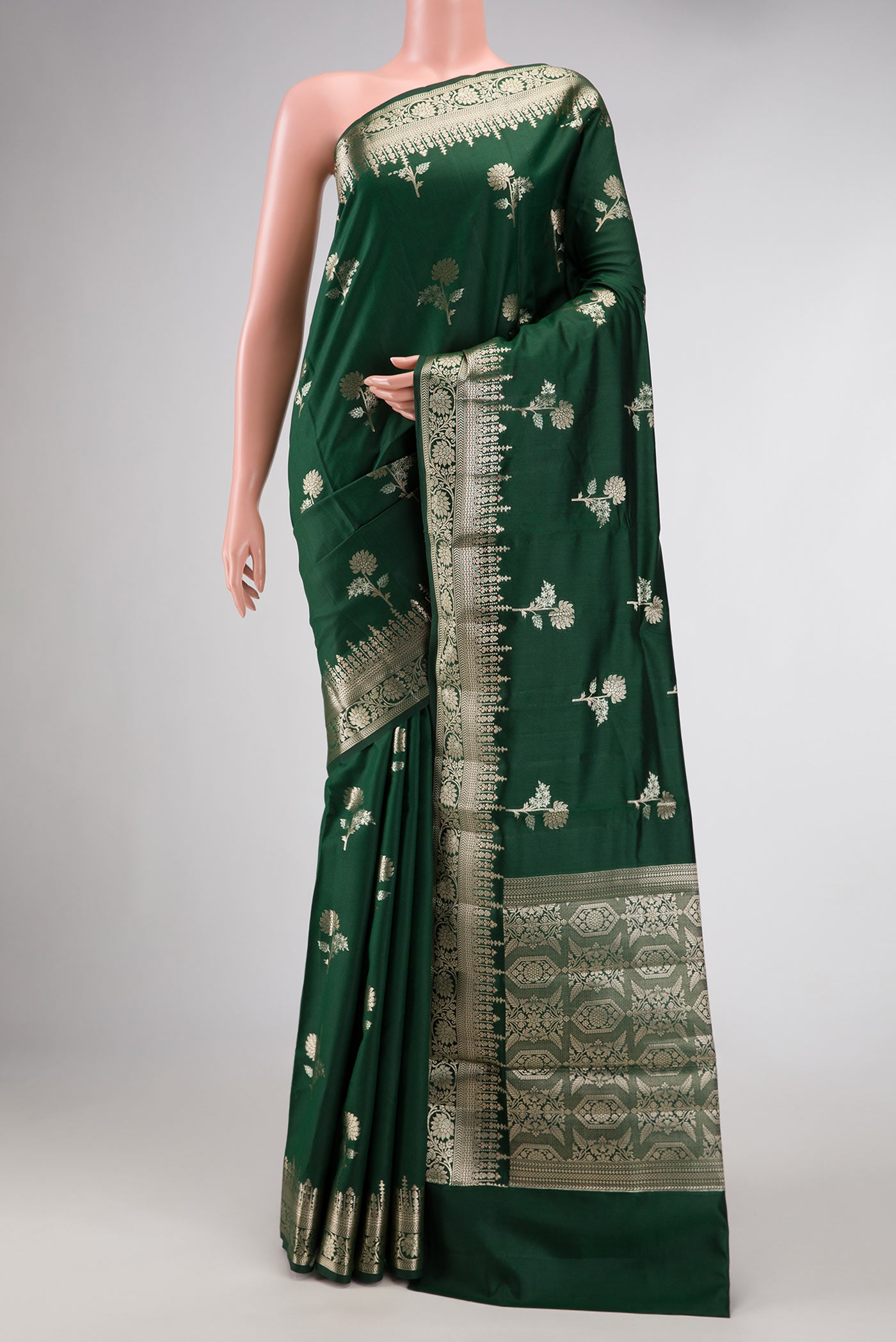 Bottle Green Dual Tone Tussar Silk Saree with Zari Butta on the body and Zari Border.  displayed on a mannequin