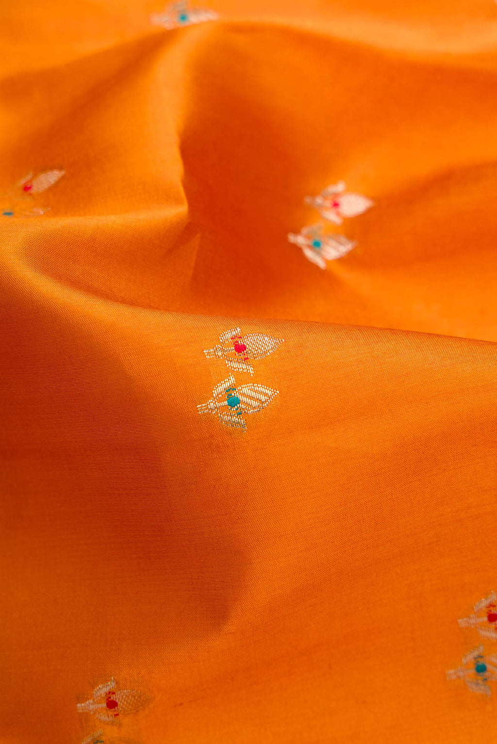 Close up of Mustard Dual Tone Tussar Silk Saree with Zari Butta on the body and Zari Border.  displaying folds