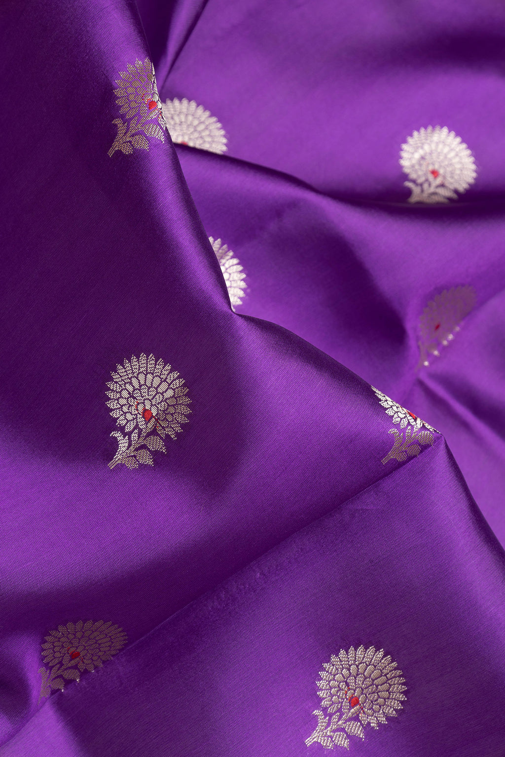 Close up of Purple Dual Tone Tussar Silk Saree with Zari Butta on the body and Zari Border.  displaying folds