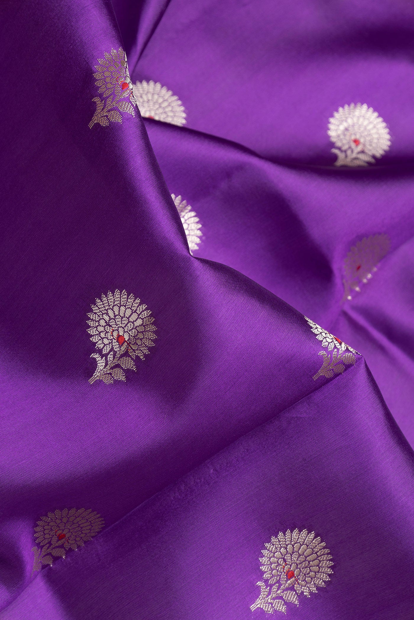 Close up of Purple Dual Tone Tussar Silk Saree with Zari Butta on the body and Zari Border.  displaying folds