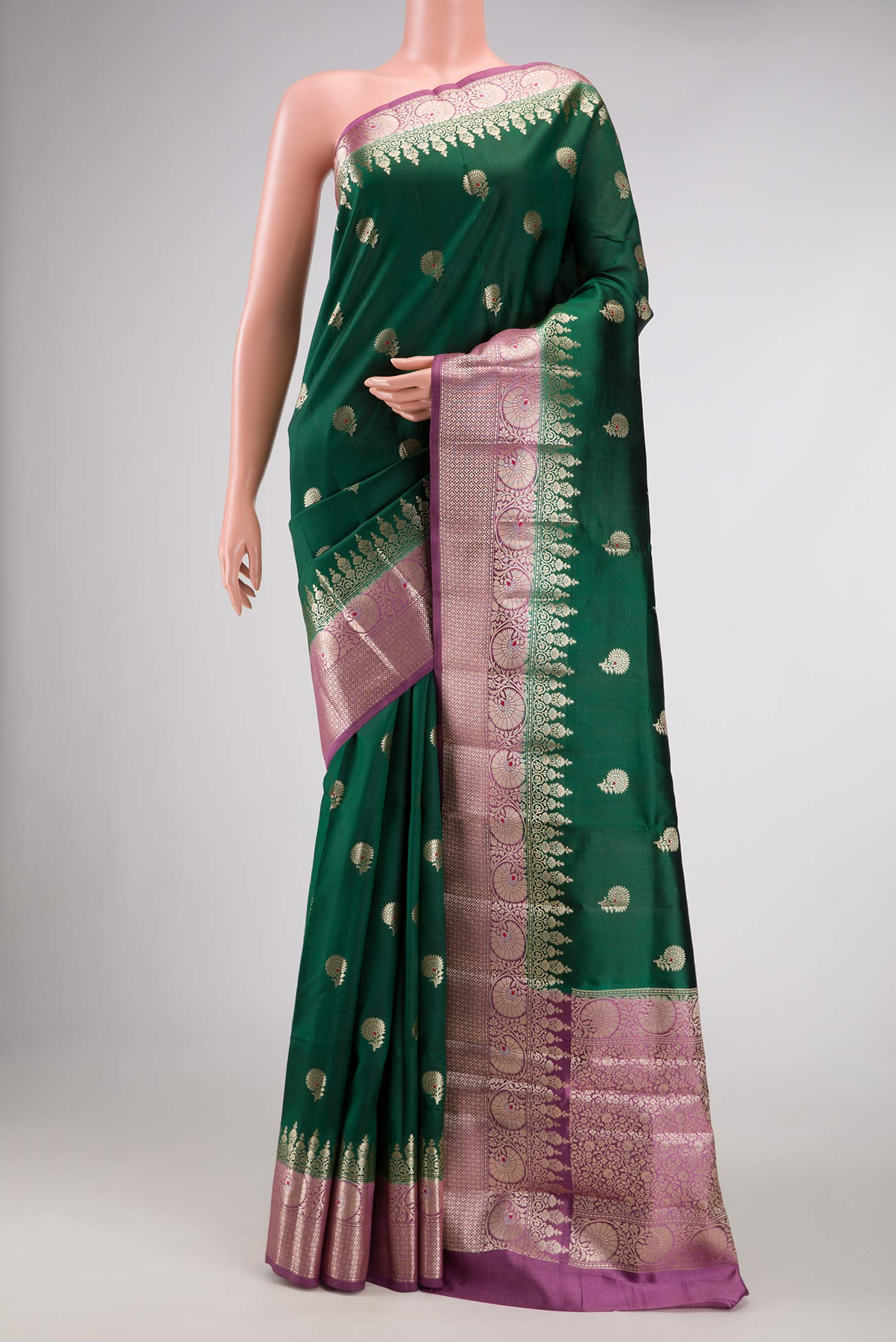 Bottle Green Dual Tone Tussar Silk Saree with Zari Butta on the body and Zari Border.  displayed on a mannequin