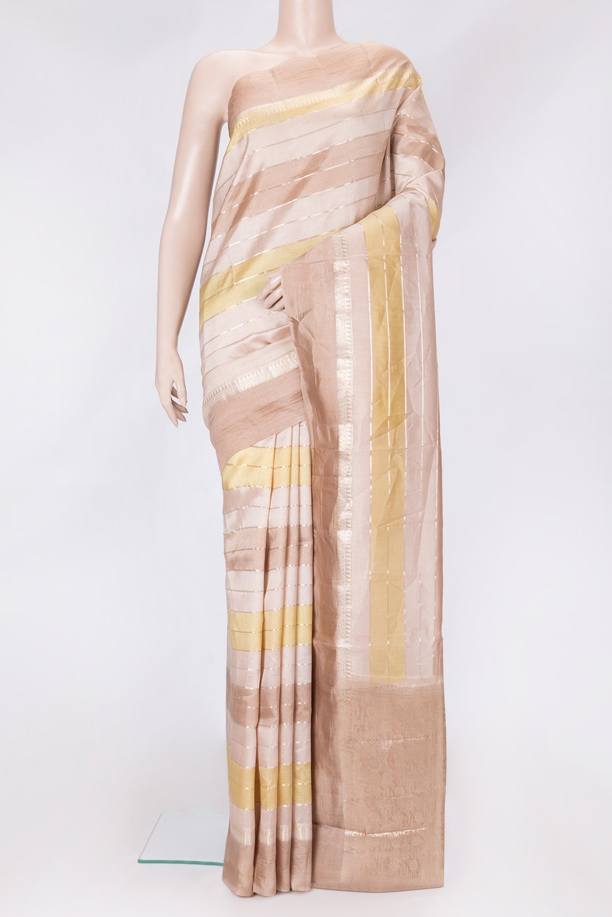Rose Gold Dual Tone Tussar Silk Saree with Stripes on the body and Zari Border.  displayed on a mannequin