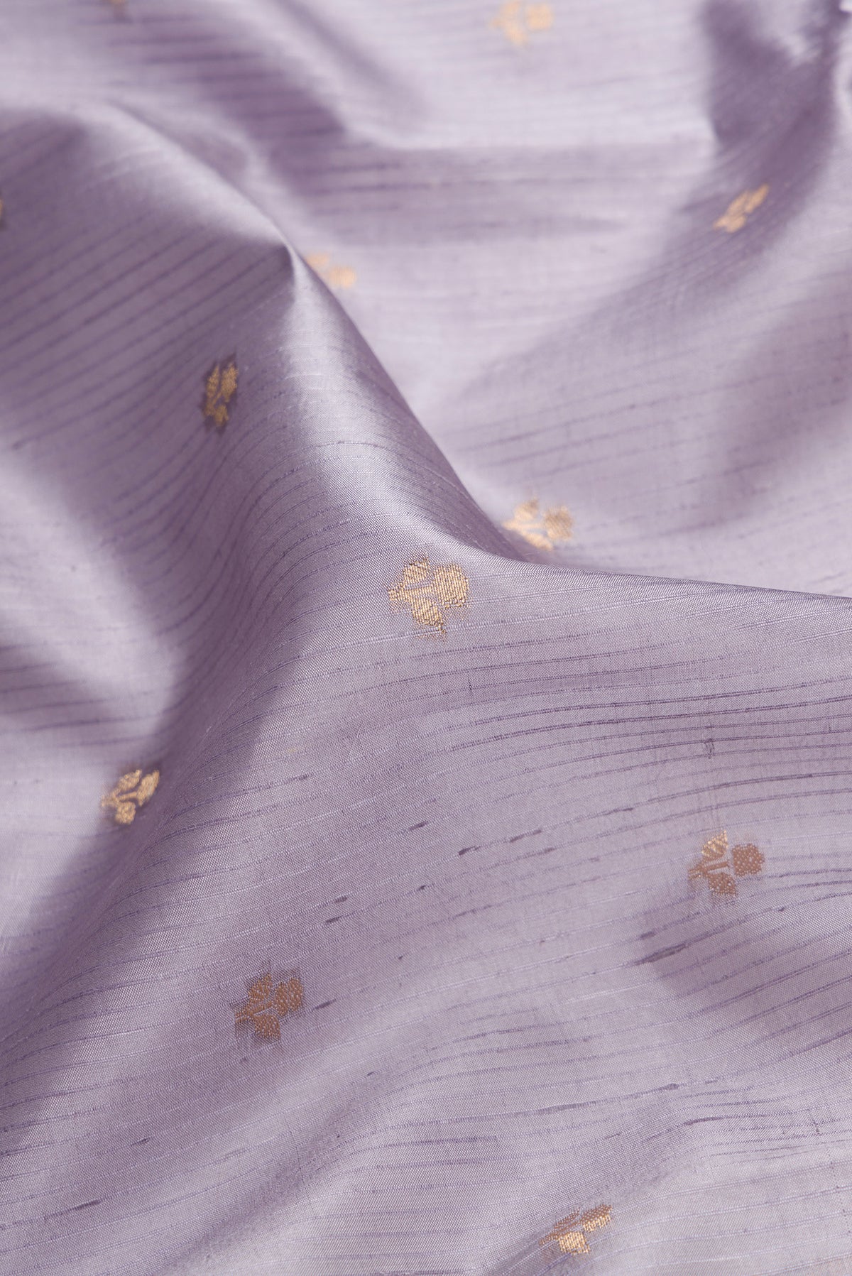 Close up of Grey Dual Tone Tussar Silk Saree with Zari Butta on the body and Fancy Border.  displaying folds