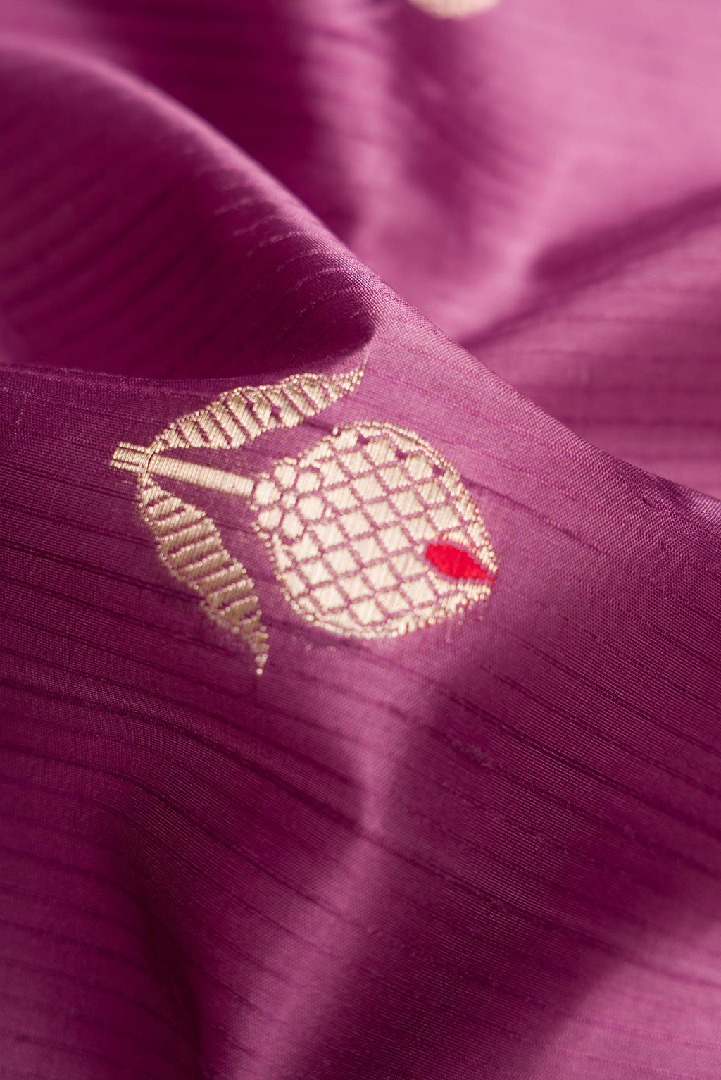 Close up of Purple Dual Tone Tussar Silk Saree with Zari Butta on the body and Zari Border.  displaying folds