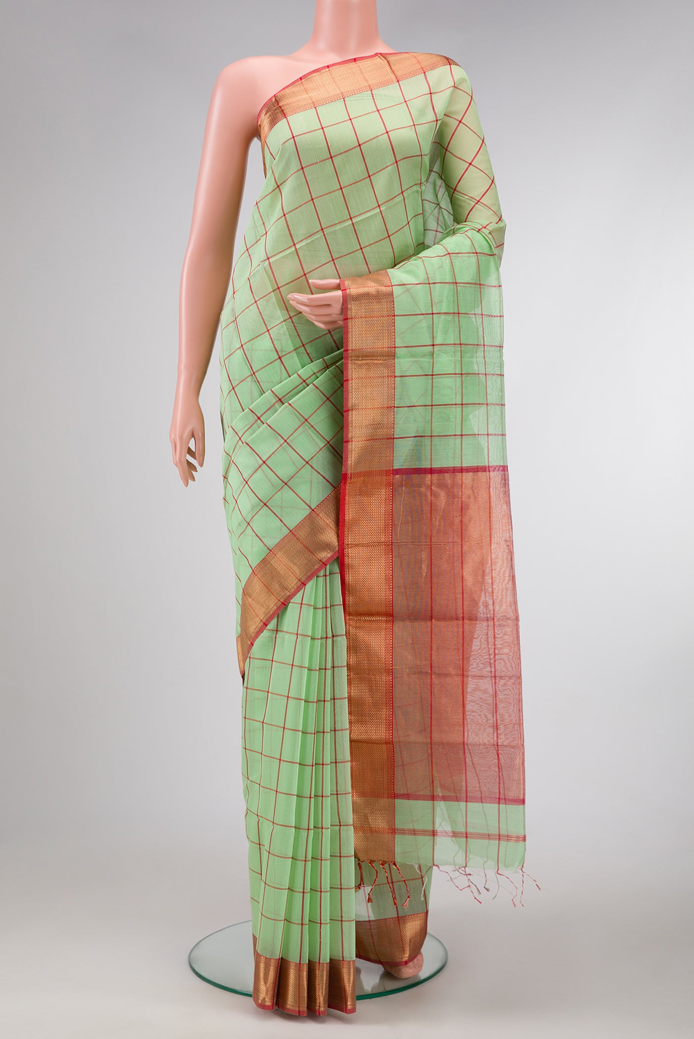 Pista Green Dual Tone Maheshwari Silk Saree with Checked design on the body and Zari Border.  displayed on a mannequin