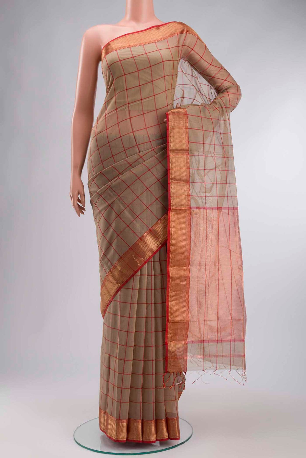Beige Maheshwari Silk Cotton Saree with Checked design on the body and Zari Border displayed on a mannequin