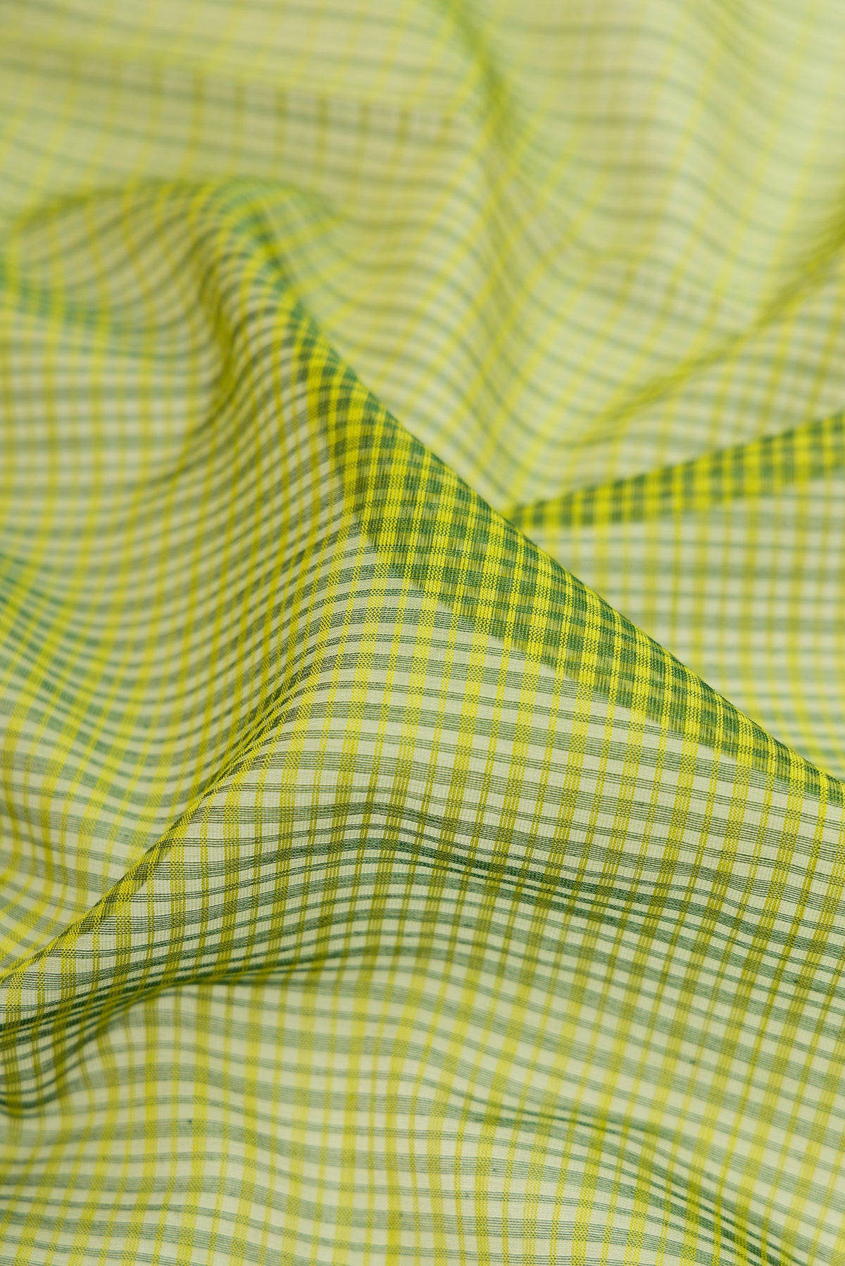 Close up of Green Maheshwari Silk Cotton Saree with Stripes on the body and Zari Border.  displaying folds