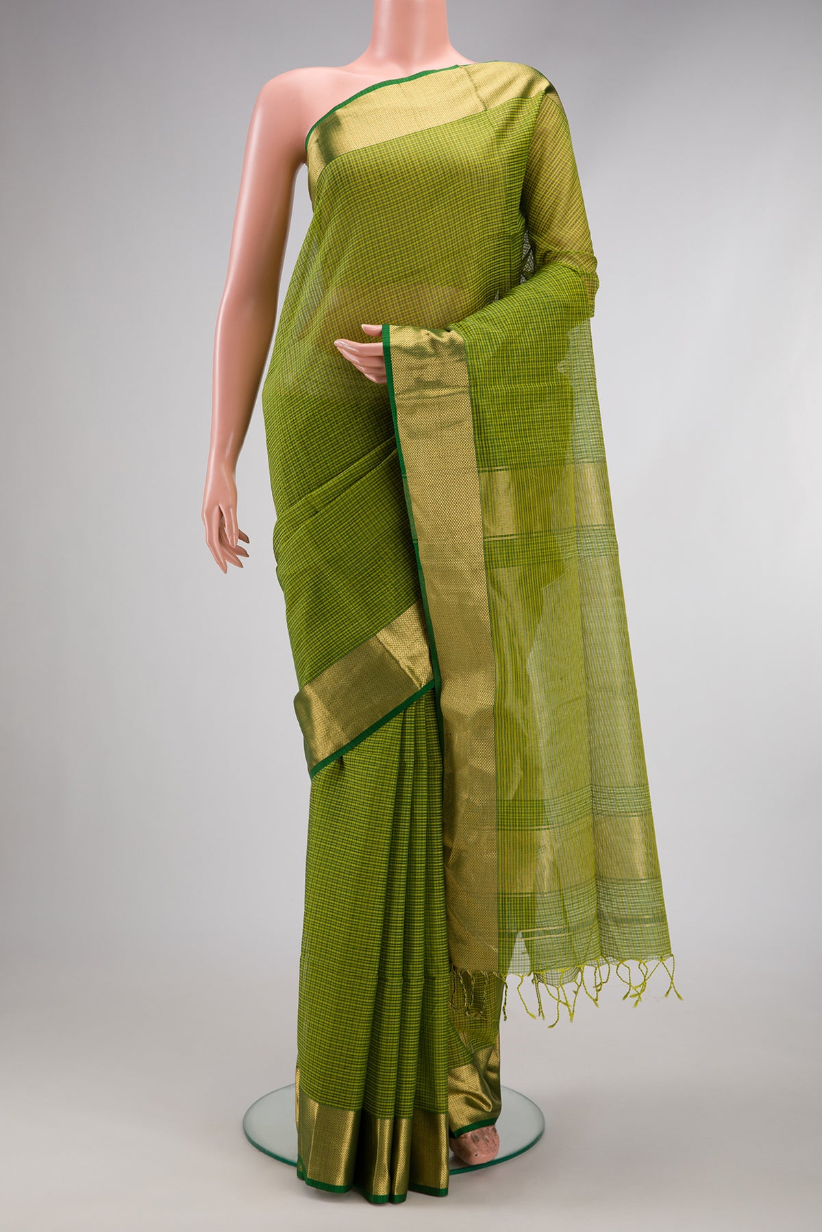 Green Maheshwari Silk Cotton Saree with Stripes on the body and Zari Border.  displayed on a mannequin