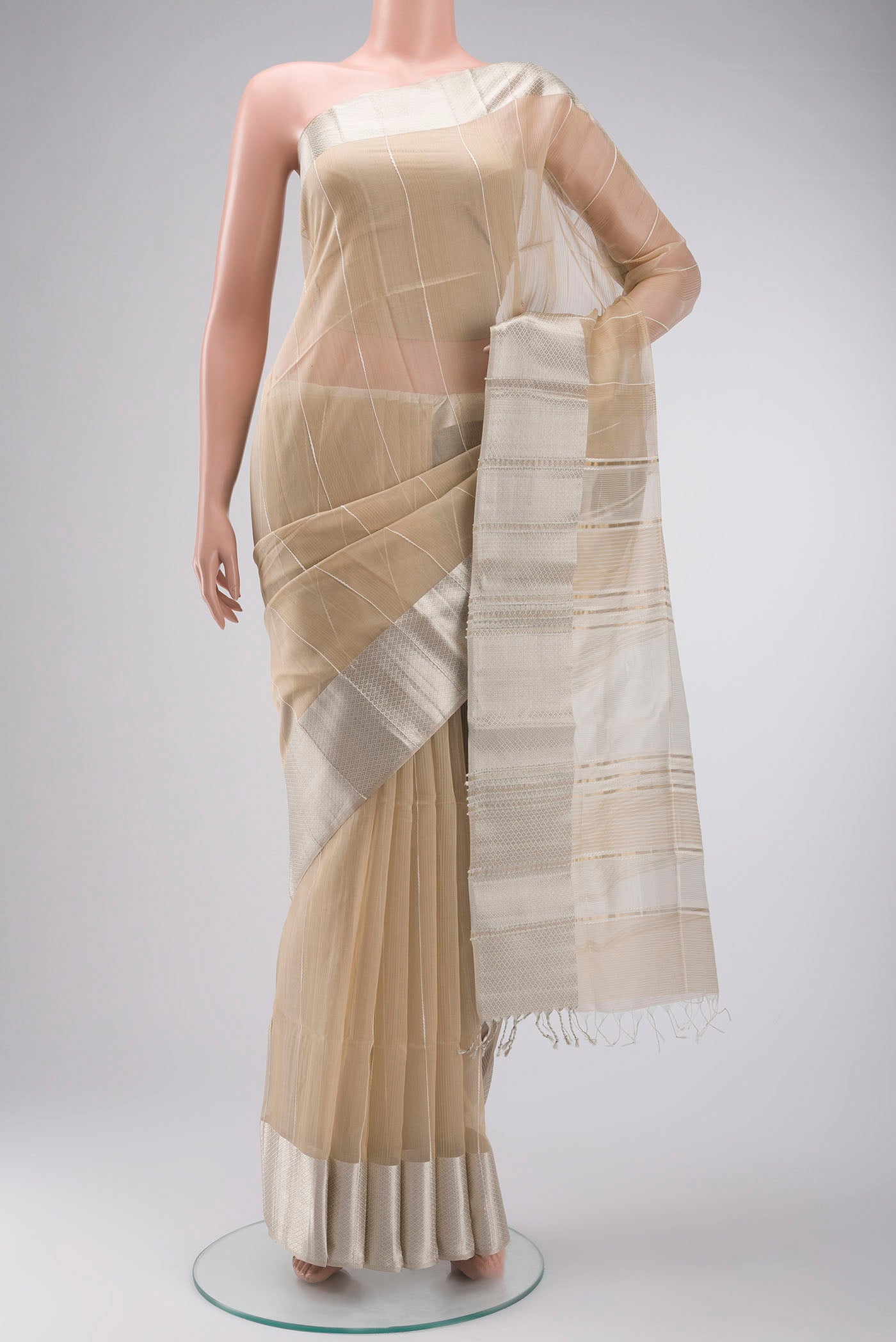 Beige Maheshwari Silk Cotton Saree with Stripes on the body and Zari Border displayed on a mannequin