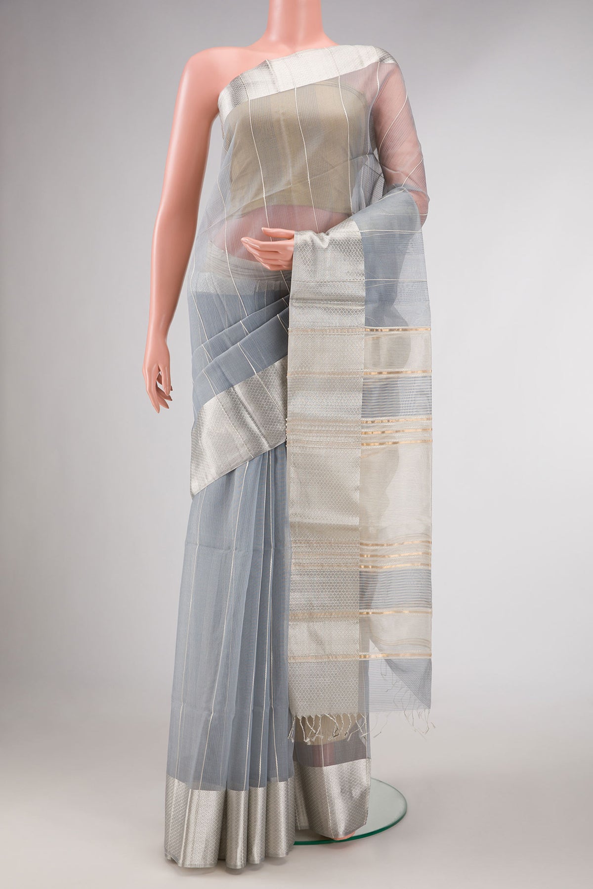 Grey Dual Tone Silk Cotton Saree with Stripes on the body and Zari Border displayed on a mannequin
