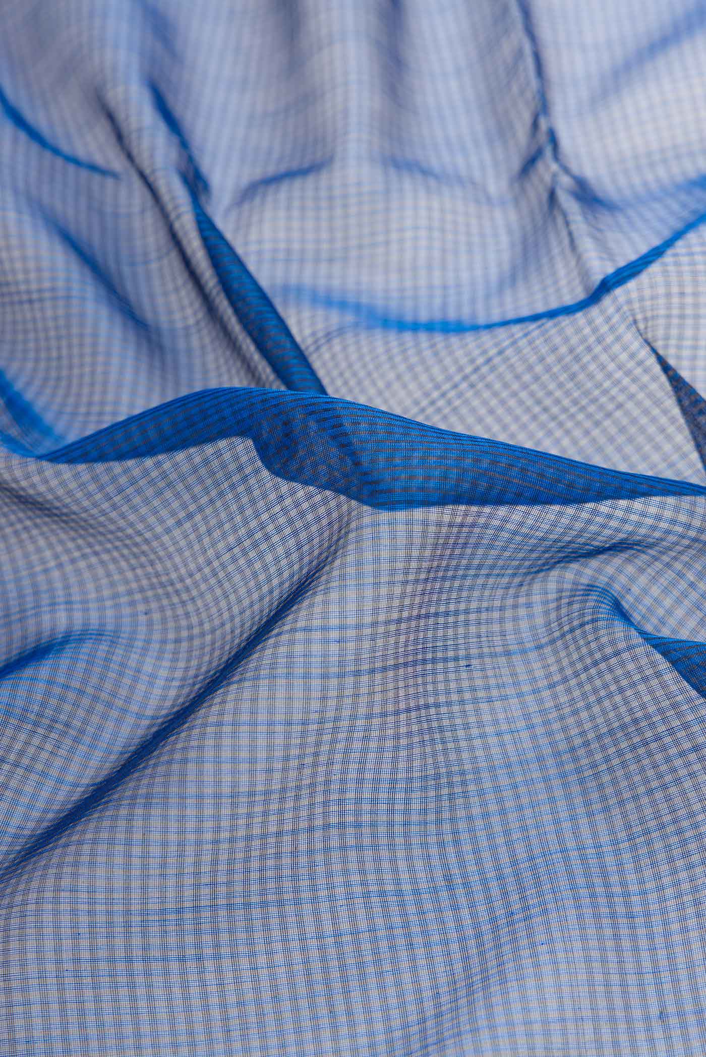 Close up of Navy Blue Dual Tone Maheshwari Silk Saree with Stripes on the body and Zari Border displaying folds