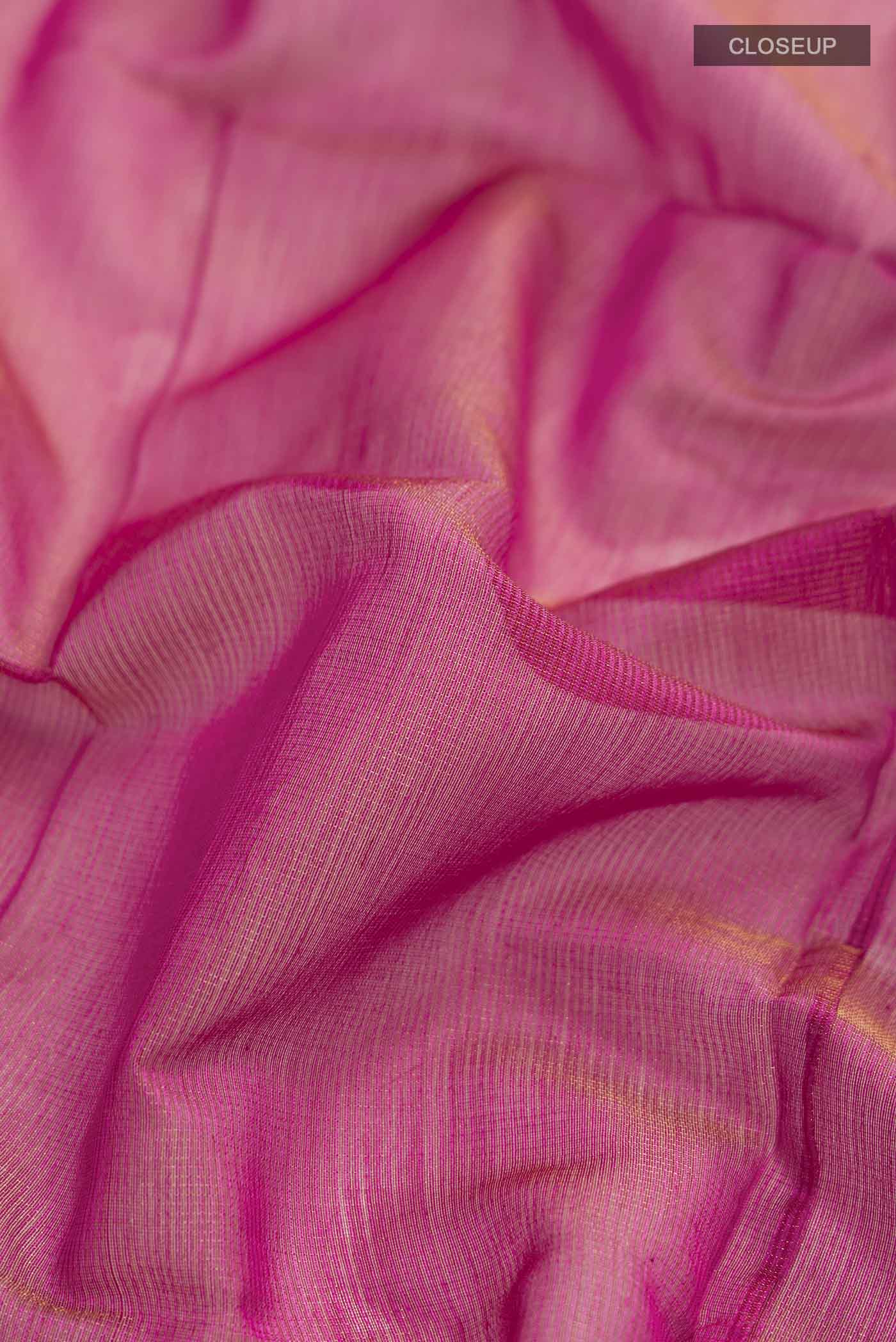Close up of Pink Maheshwari Silk Cotton Saree with Checked design on the body and Zari Border displaying folds
