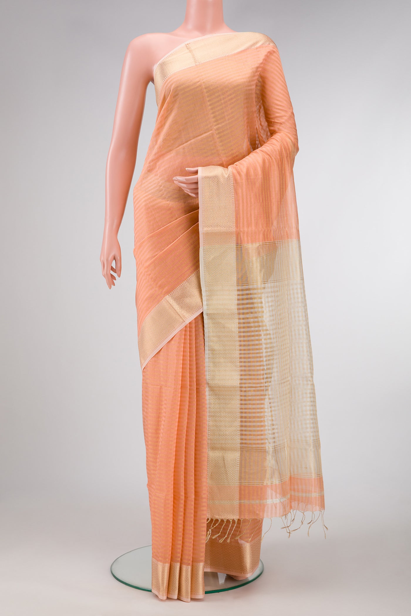 Golden Peach Dual Tone Maheshwari Silk Saree with Stripes on the body and Zari Border.  displayed on a mannequin