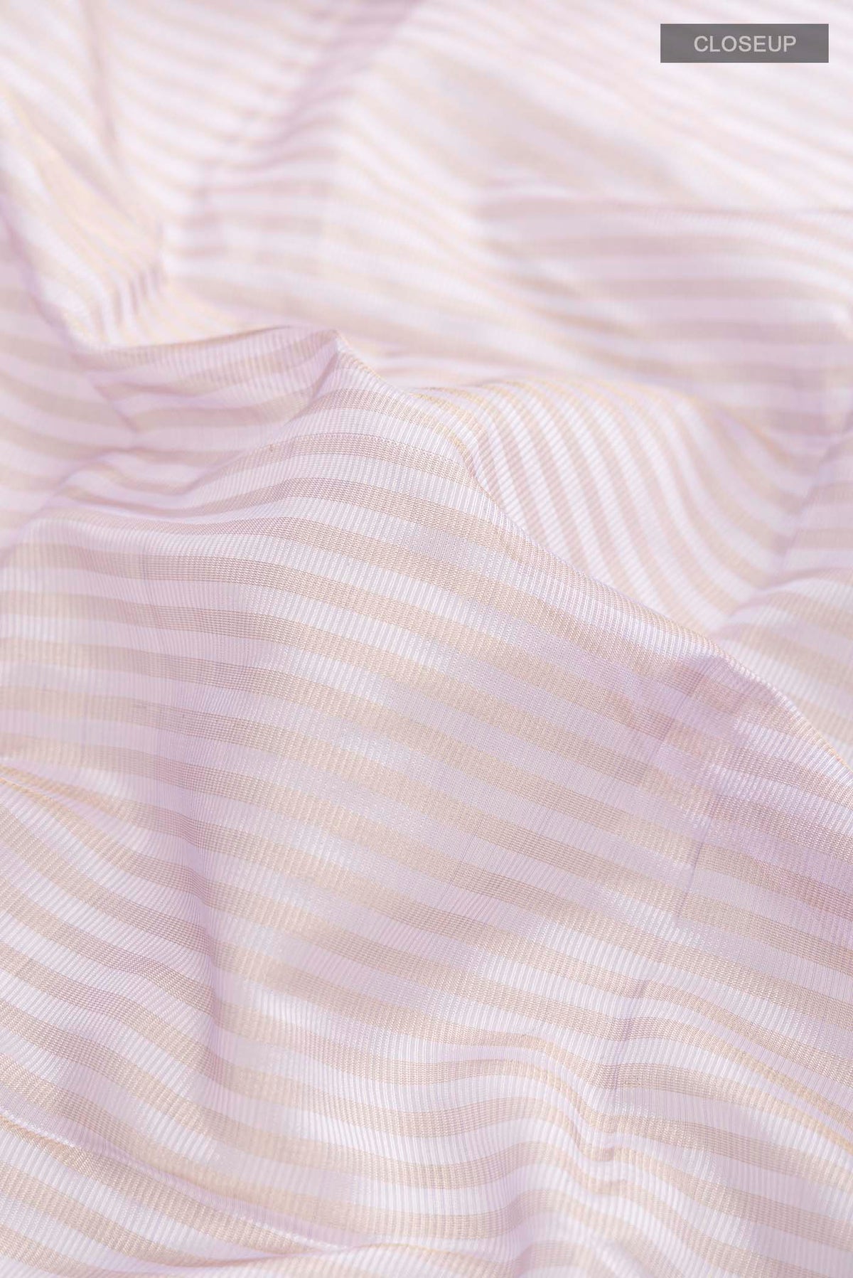 Close up of Lavender Maheshwari Silk Cotton Saree with Stripes on the body and Zari Border displaying folds