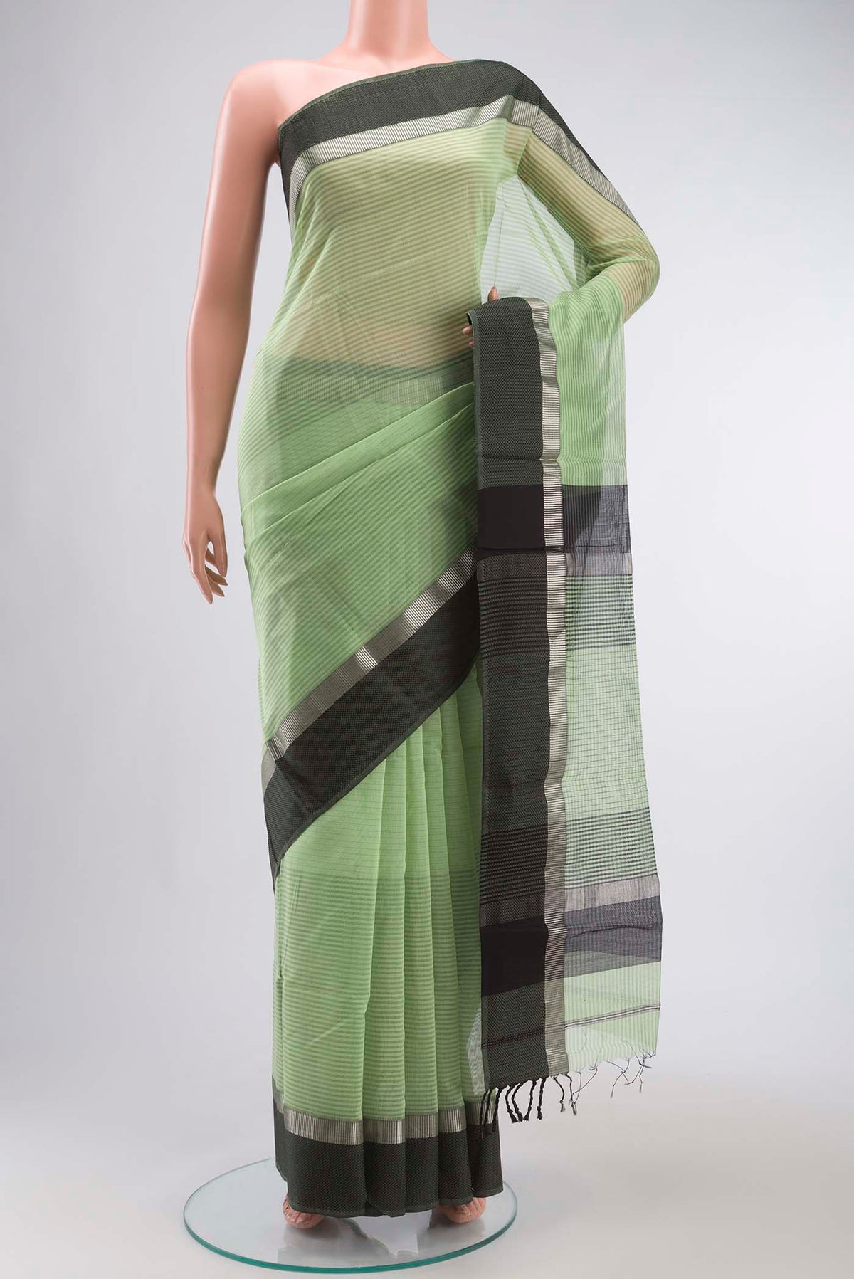 Green Maheshwari Silk Cotton Saree with Stripes on the body and Thread Border displayed on a mannequin