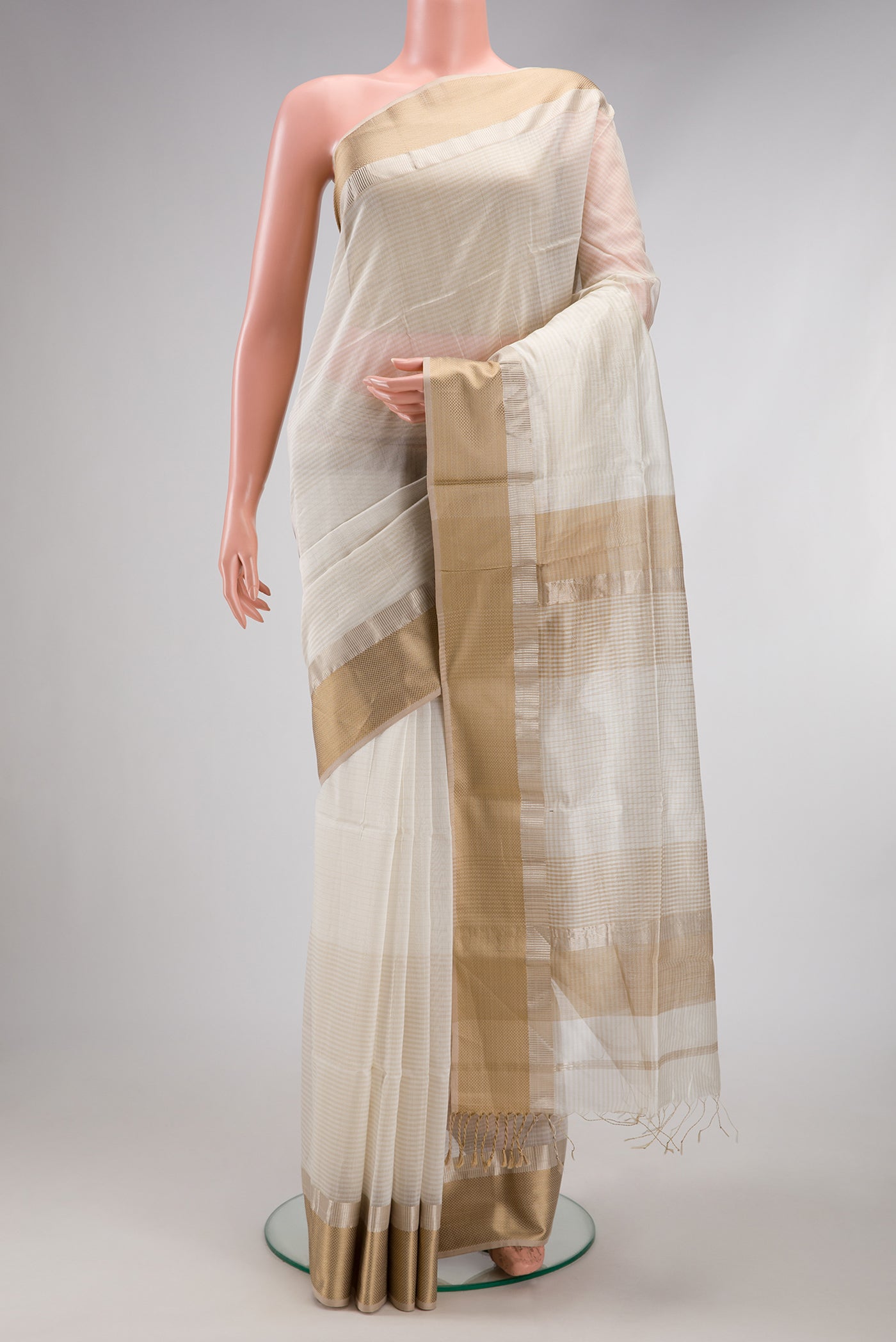 Off White Dual Tone Maheshwari Silk Cotton Saree with Stripes on the body and Zari Border.  displayed on a mannequin