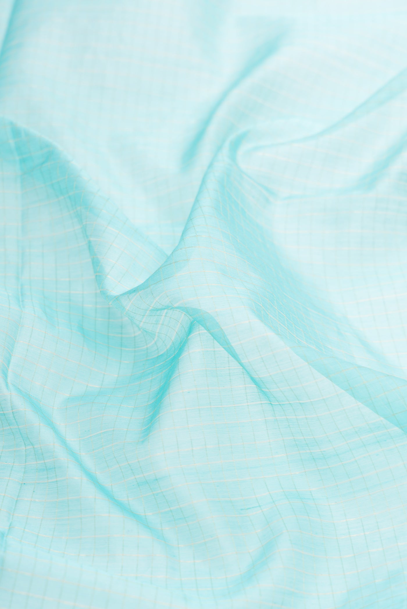 Close up of Sky Blue Dual Tone Maheshwari Silk Saree with Checked design on the body and Zari Border.  displaying folds