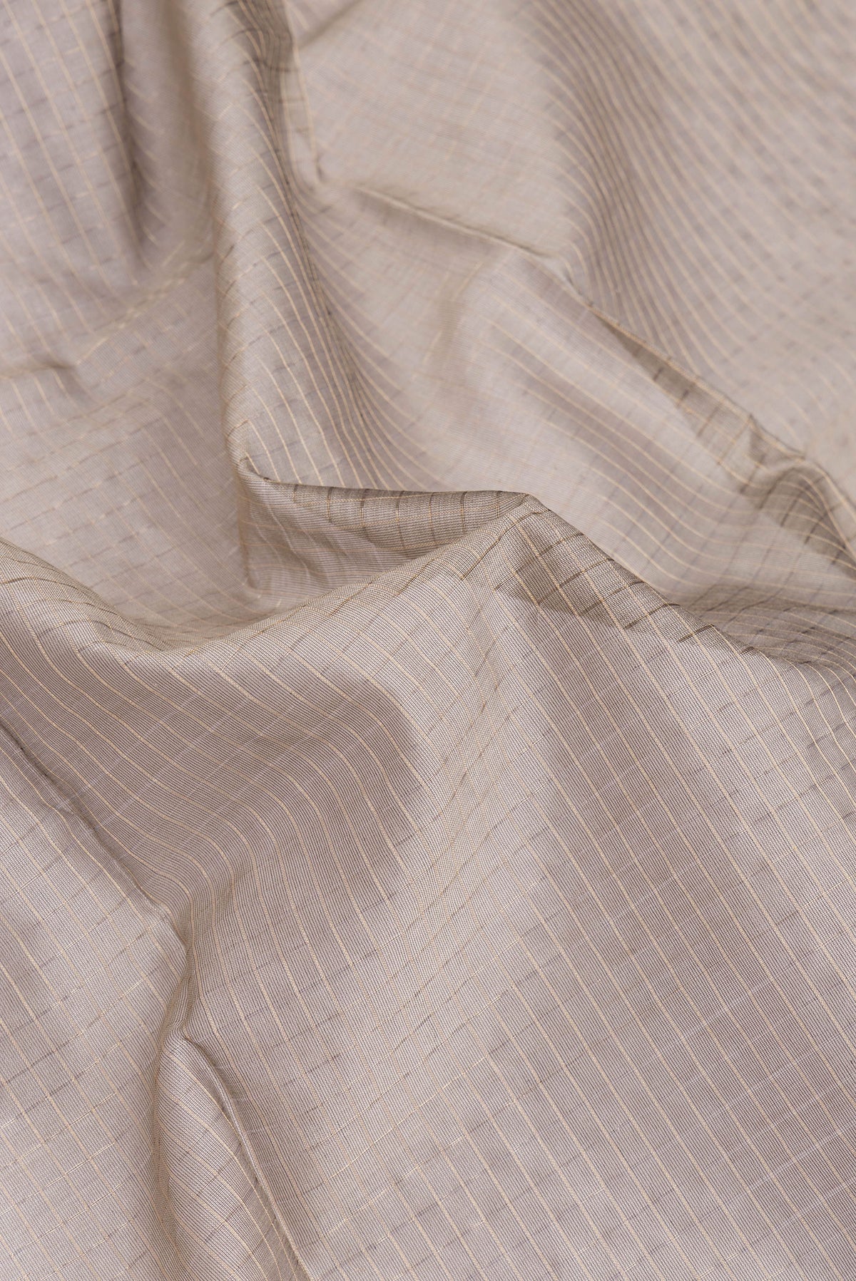 Close up of Grey Dual Tone Maheshwari Silk Cotton Saree with Checked design on the body and Zari Border.  displaying folds