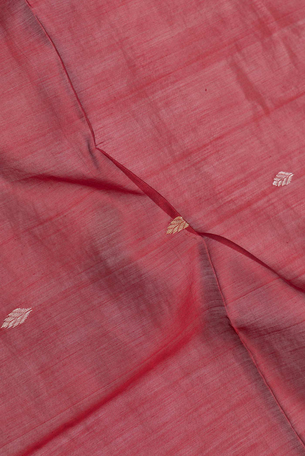 Close up of Maroon Dual Tone Maheshwari Silk Saree with Zari Butta on the body and Zari Border.  displaying folds