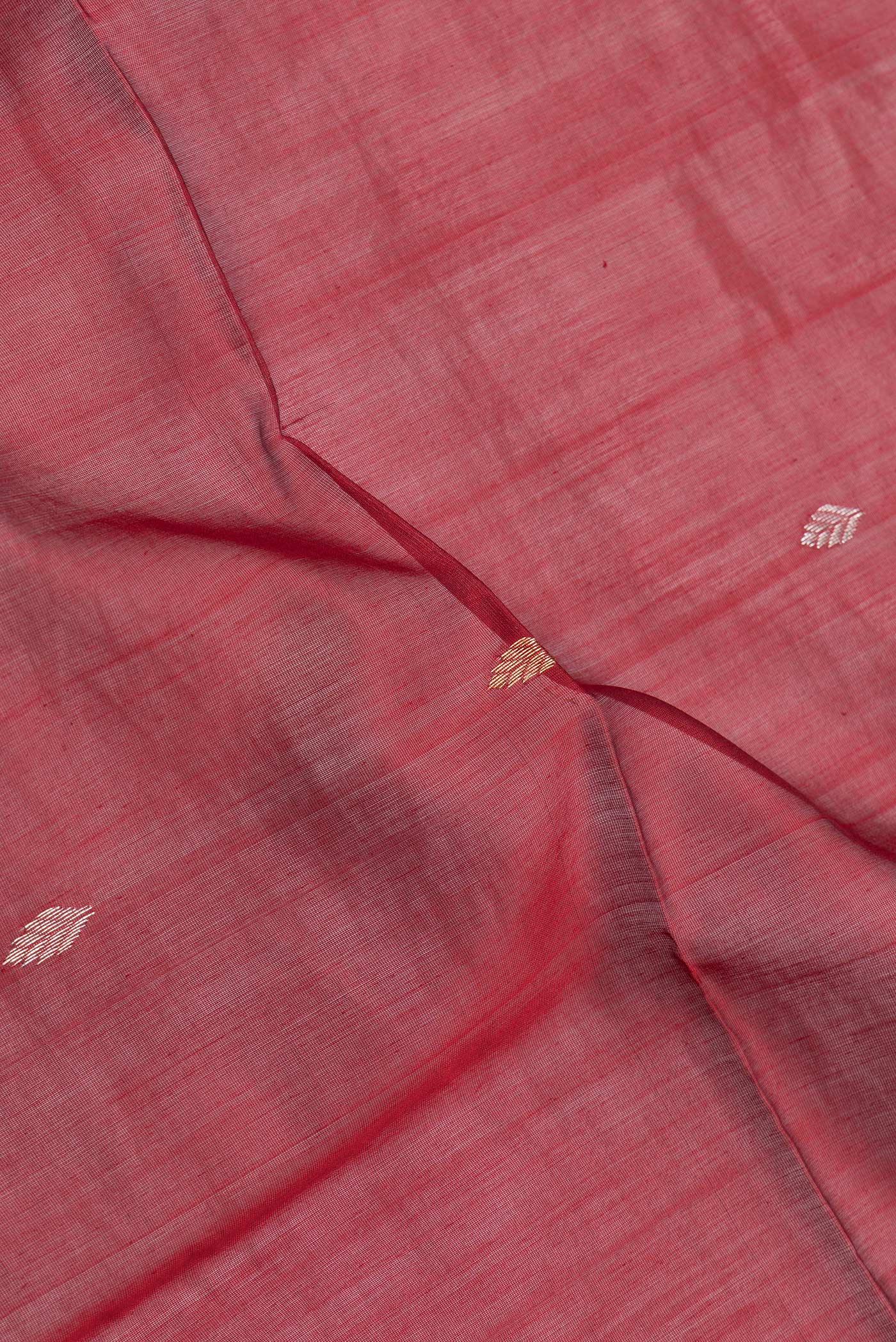 Close up of Maroon Dual Tone Maheshwari Silk Saree with Zari Butta on the body and Zari Border.  displaying folds