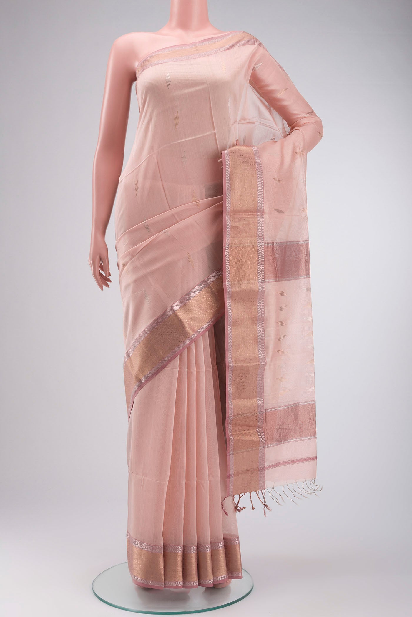 Peach Maheshwari Silk Cotton Saree with Zari Butta on the body and Zari Border displayed on a mannequin