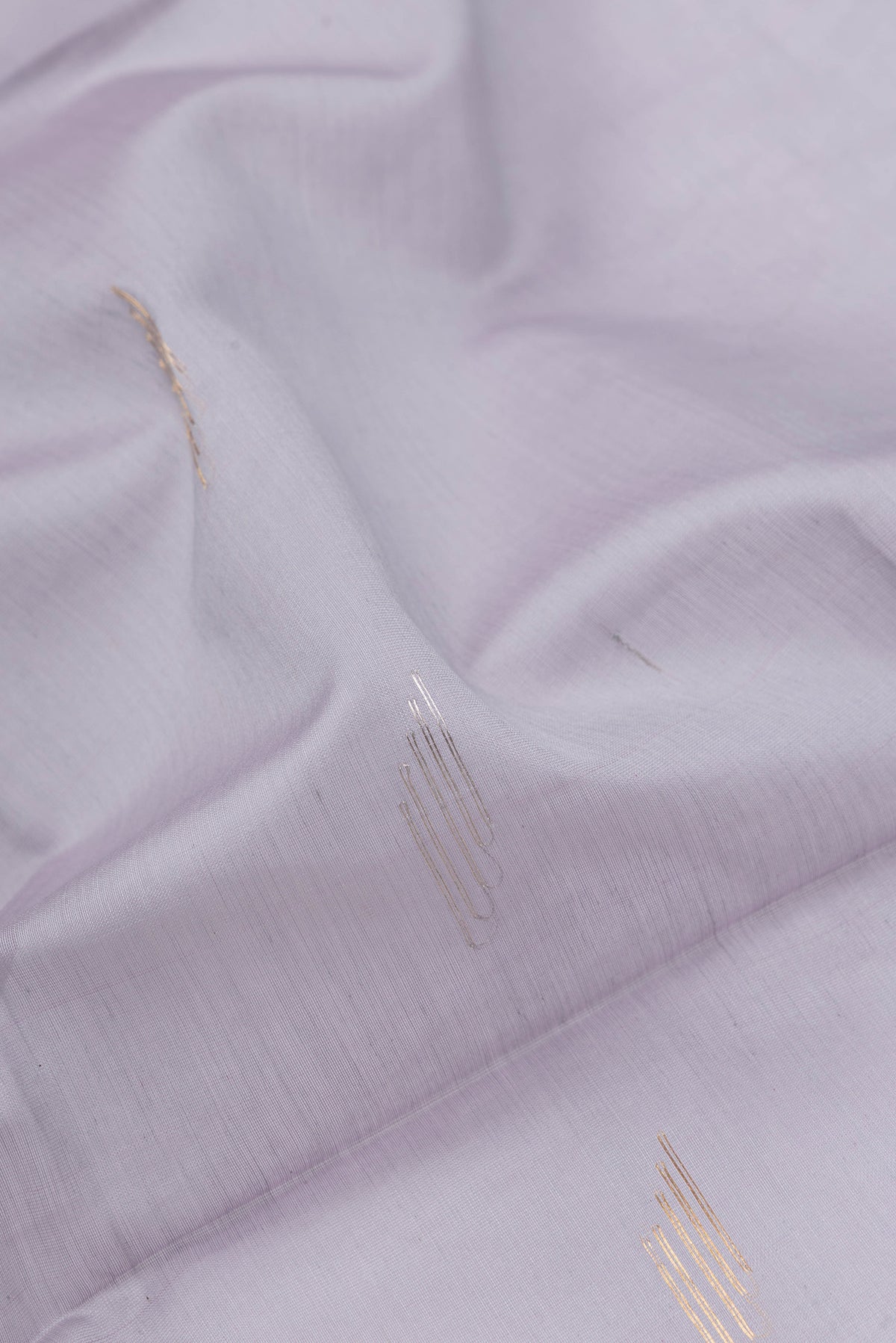 Close up of Grey Dual Tone Maheshwari Silk Saree with Zari Butta on the body and Zari Border.  displaying folds