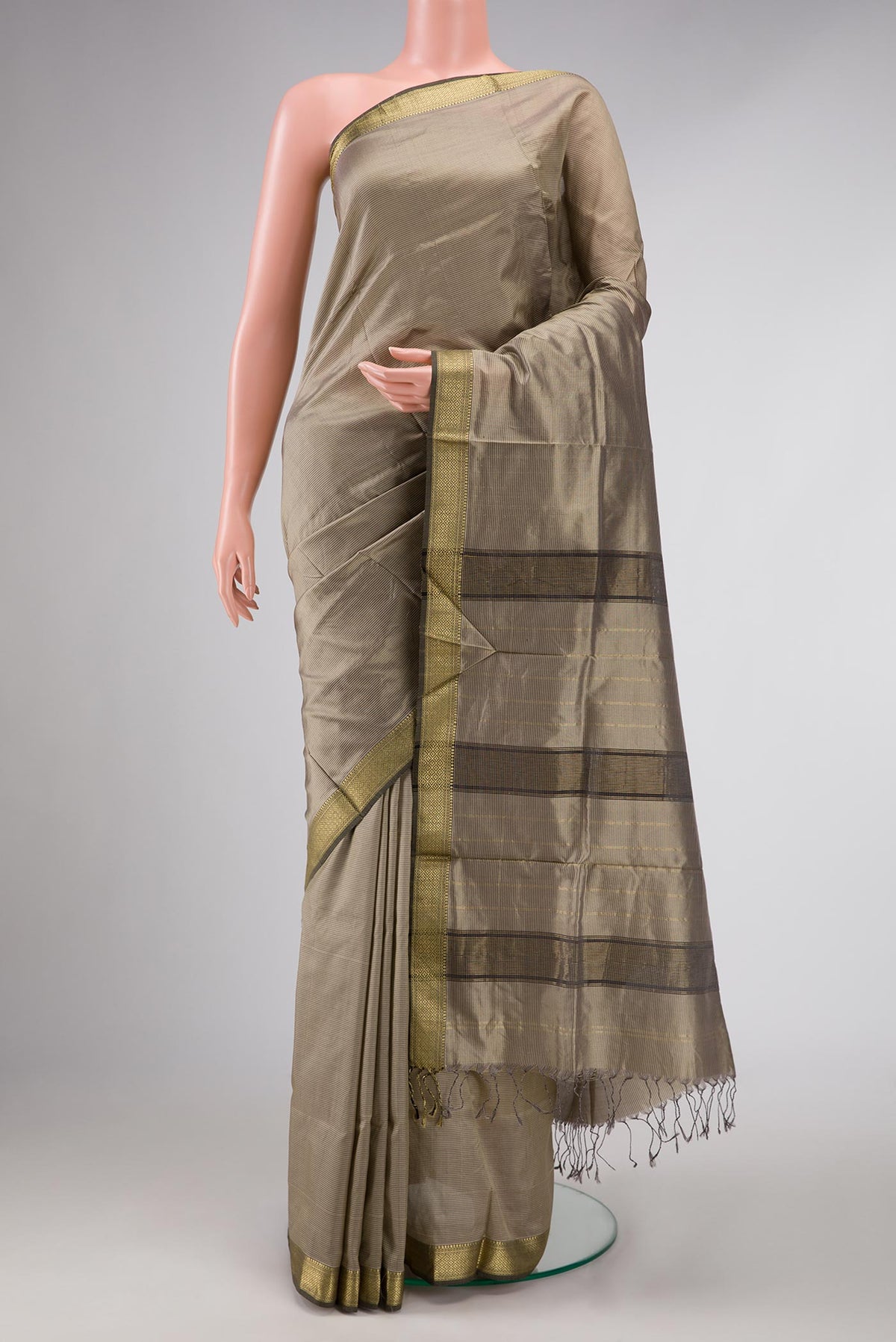 Dark Beige Dual Tone Maheshwari Silk Saree with Stripes on the body and Zari Border displayed on a mannequin